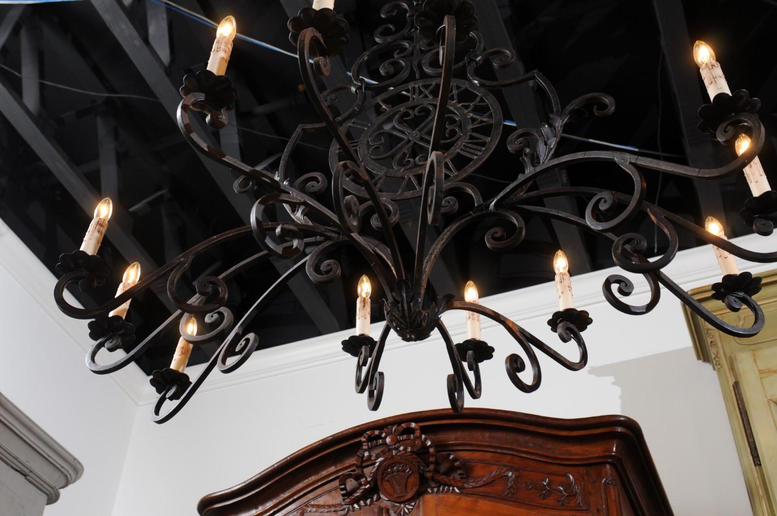 French 12-Light Wrought-Iron Chandelier with Clock Motif and Scrolling Armature In Good Condition For Sale In Atlanta, GA