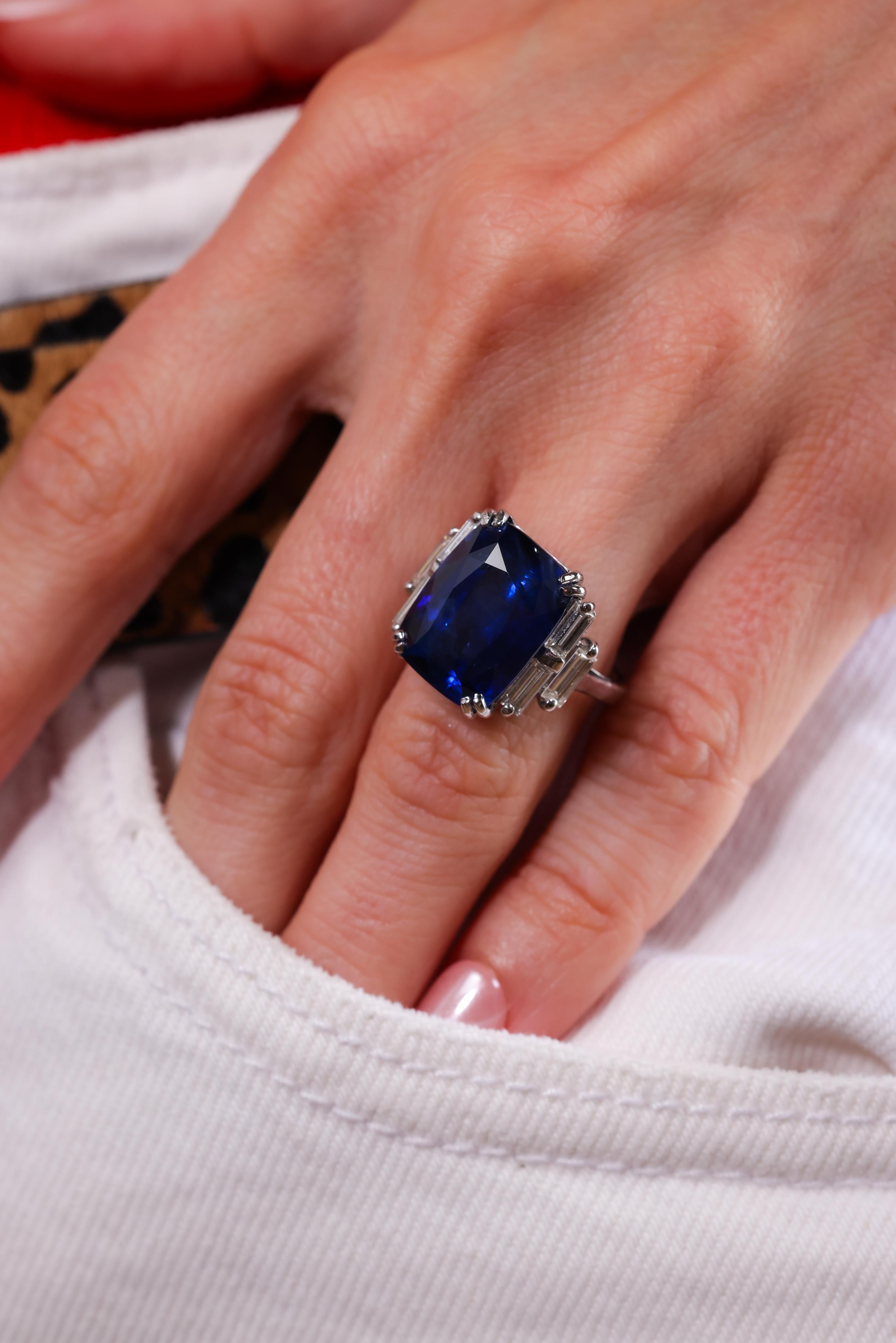 Center Stone: Blue sapphire
Cut: Cushion
Weight: 15.49 carats 
Origin: Ceylon 
Treatment: Heated
Accent Stone: 6 diamonds 
Cut: Baguette 
Weight: 0.80 carats 
Color: H-I 
Clarity: VS
Metal: 18k white gold 
Circa: 1980s 
Hallmarks: French eagle