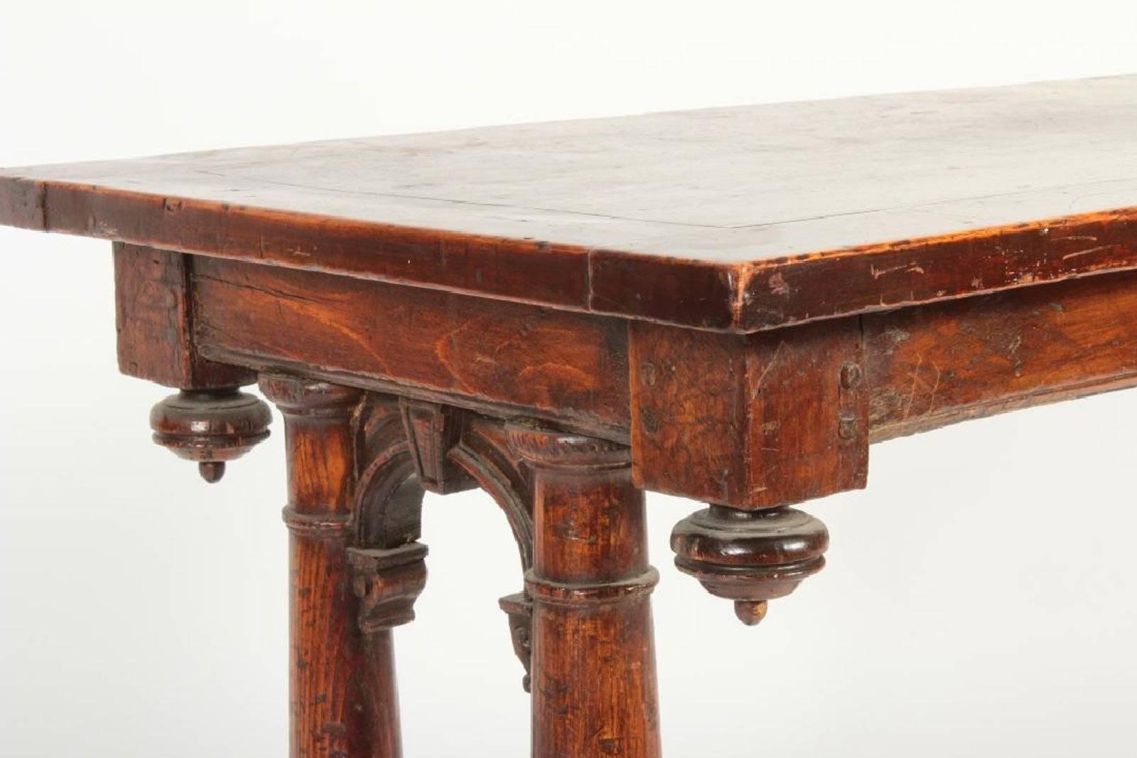 A remarkable 16th century period French hall or center table with carved walnut top and four swelling columns on H-stretcher base.

Label affixed to underside with title and description 