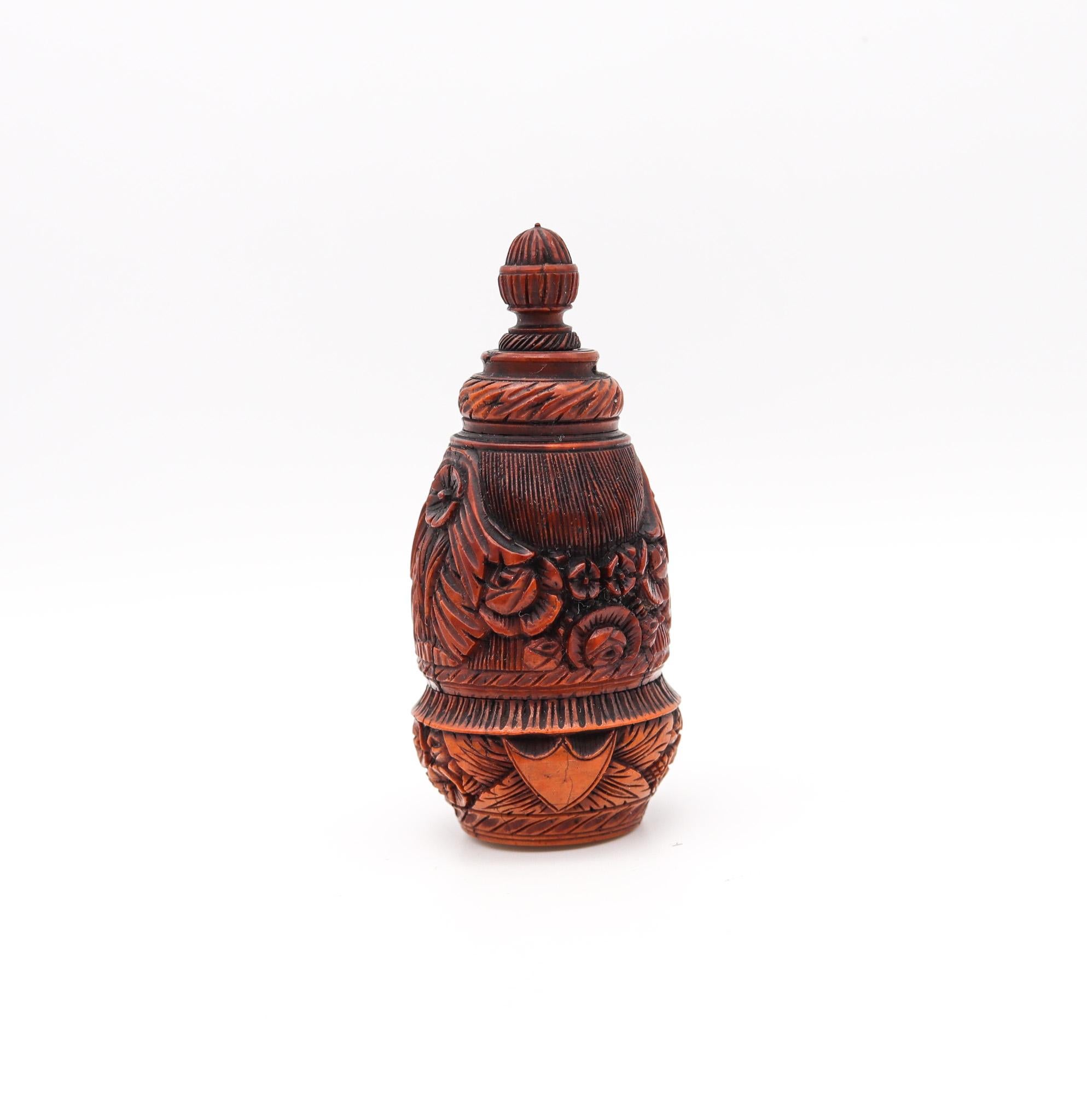 Pocket snuff flask carved from coquille nut.

Amazing small pocket snuff bottle, carved from a large coquille nut. This antique piece was created in the shape of a spinning top with two secret compartments which can be unscrewed to open. Made in the