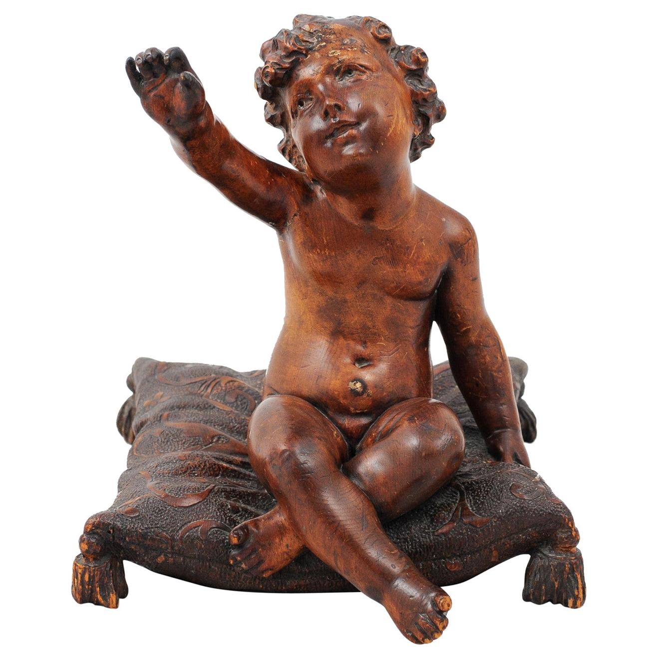 French 1780s Baroque Style Walnut Sculpture of a Putto Sitting on a Pillow For Sale