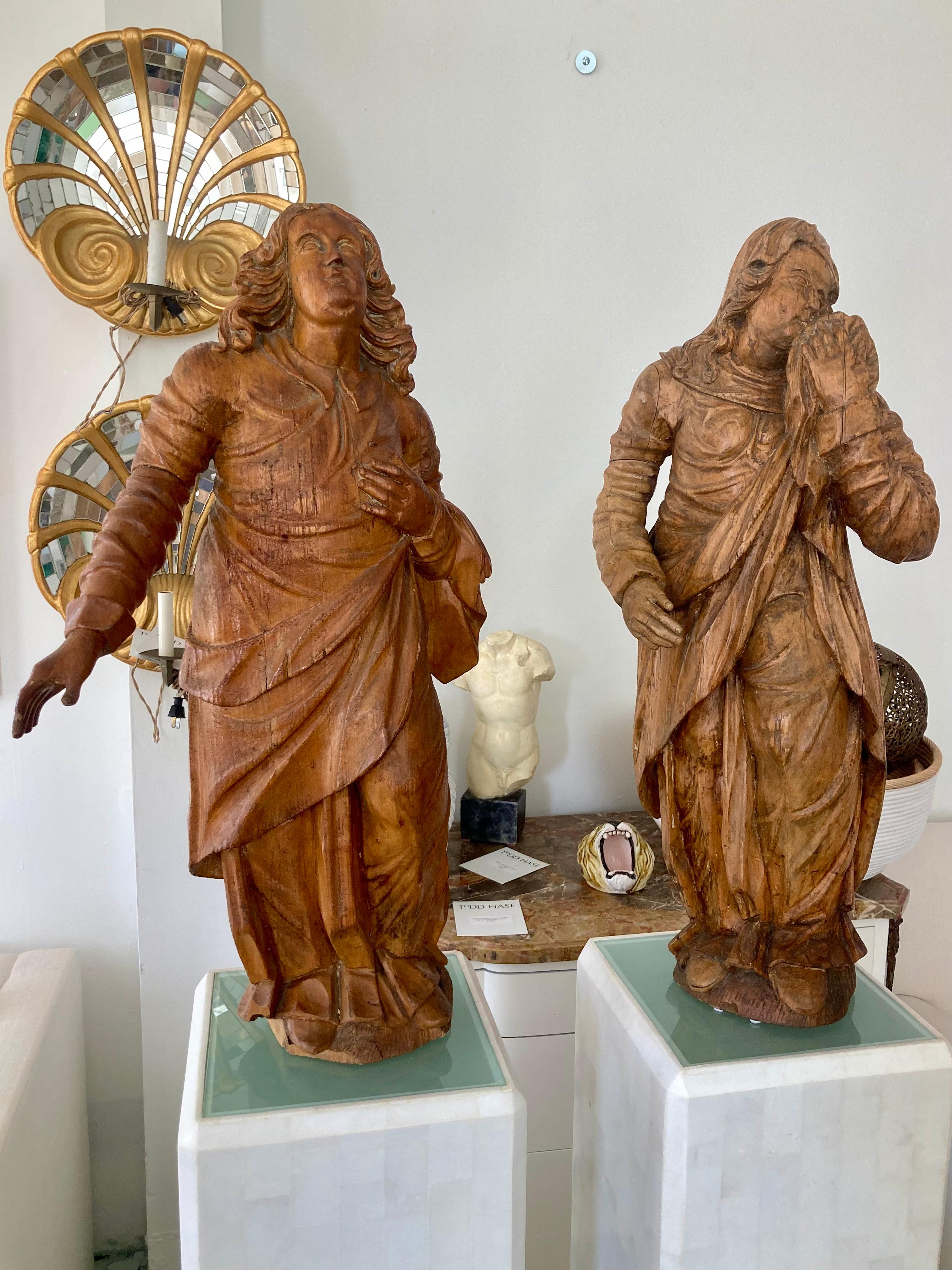 Beautiful pair of French 17th Century Baroque carved wood figural sculptures. Amazing carving details with fabrics and faces being perfectly detailed. Each is made of solid wood in a natural wood tone. Add some classical French Style to your home.