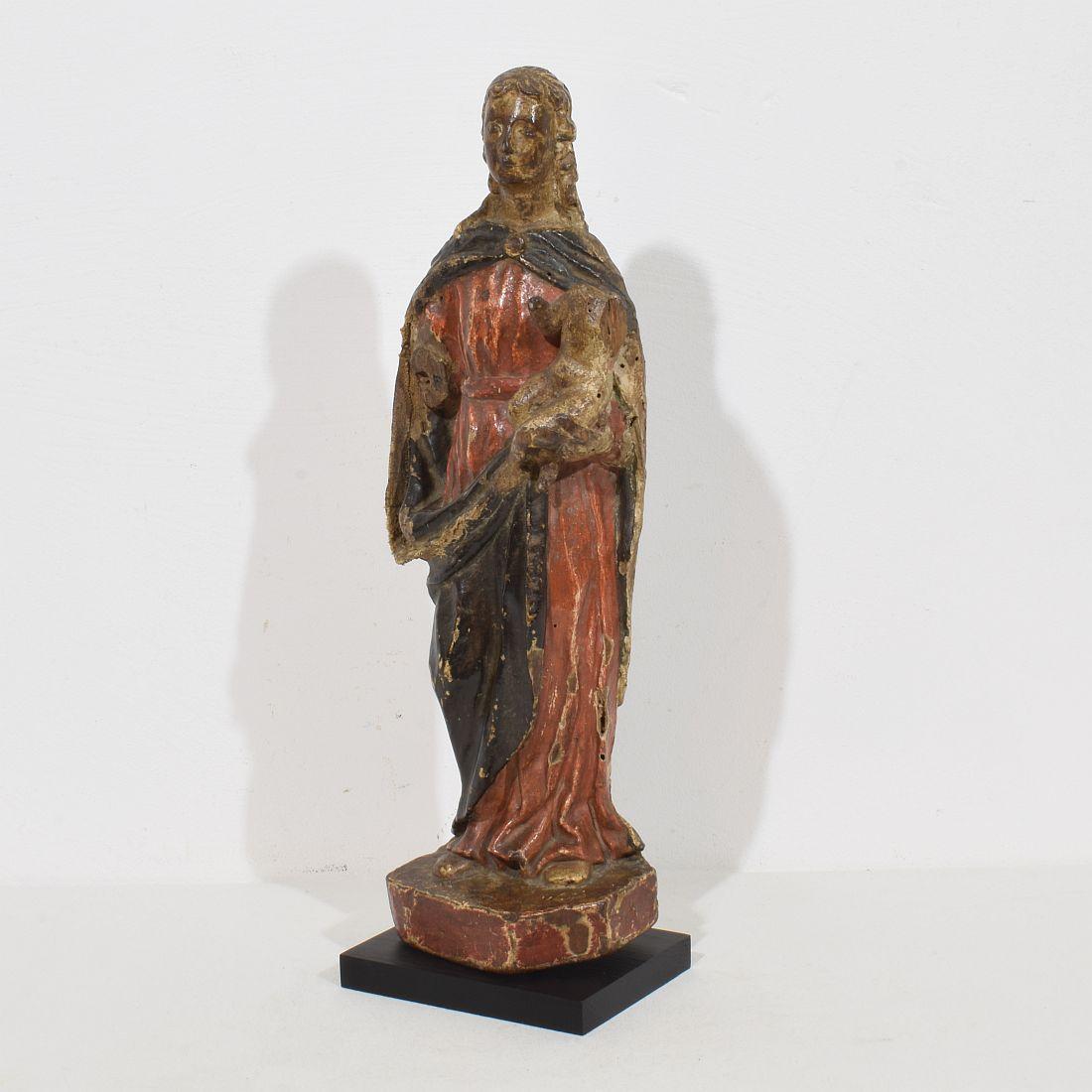 Lovely hand carved wooden Madonna with child with traces of old color. Despite of the fact this piece has several losses , she has a wonderful and strong expression and beautiful old restorations with textile. Unique period piece.
France, circa