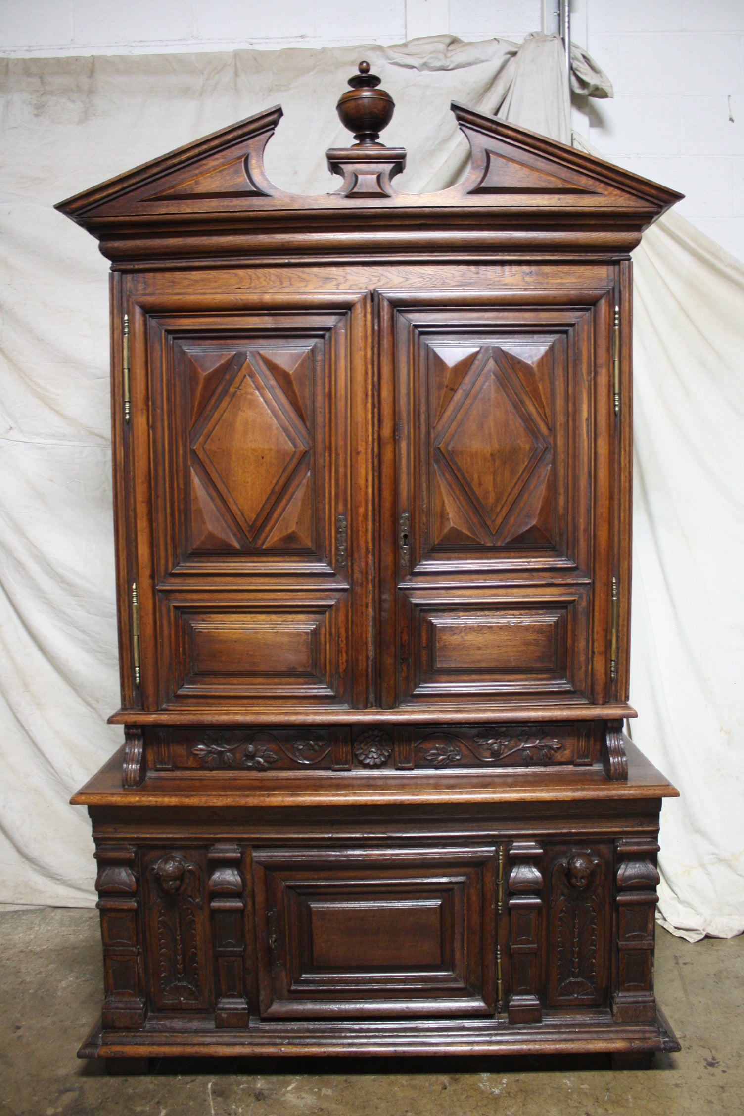 What a wonderful piece, full of character with the ornaments at the base and the putties carved in the wood.