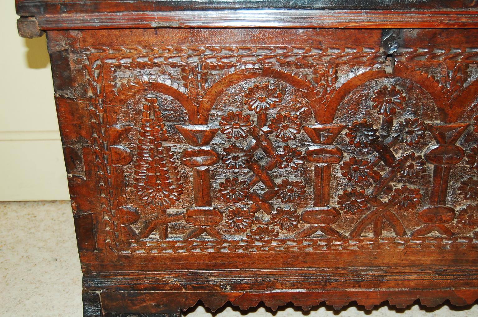 

  French 17th century baroque carved walnut coffer or blanket chest.  This quite early coffer is dovetailed with an extensively carved front of pine trees and blossoms arranged under classic arches and columns.   The three center arches contain