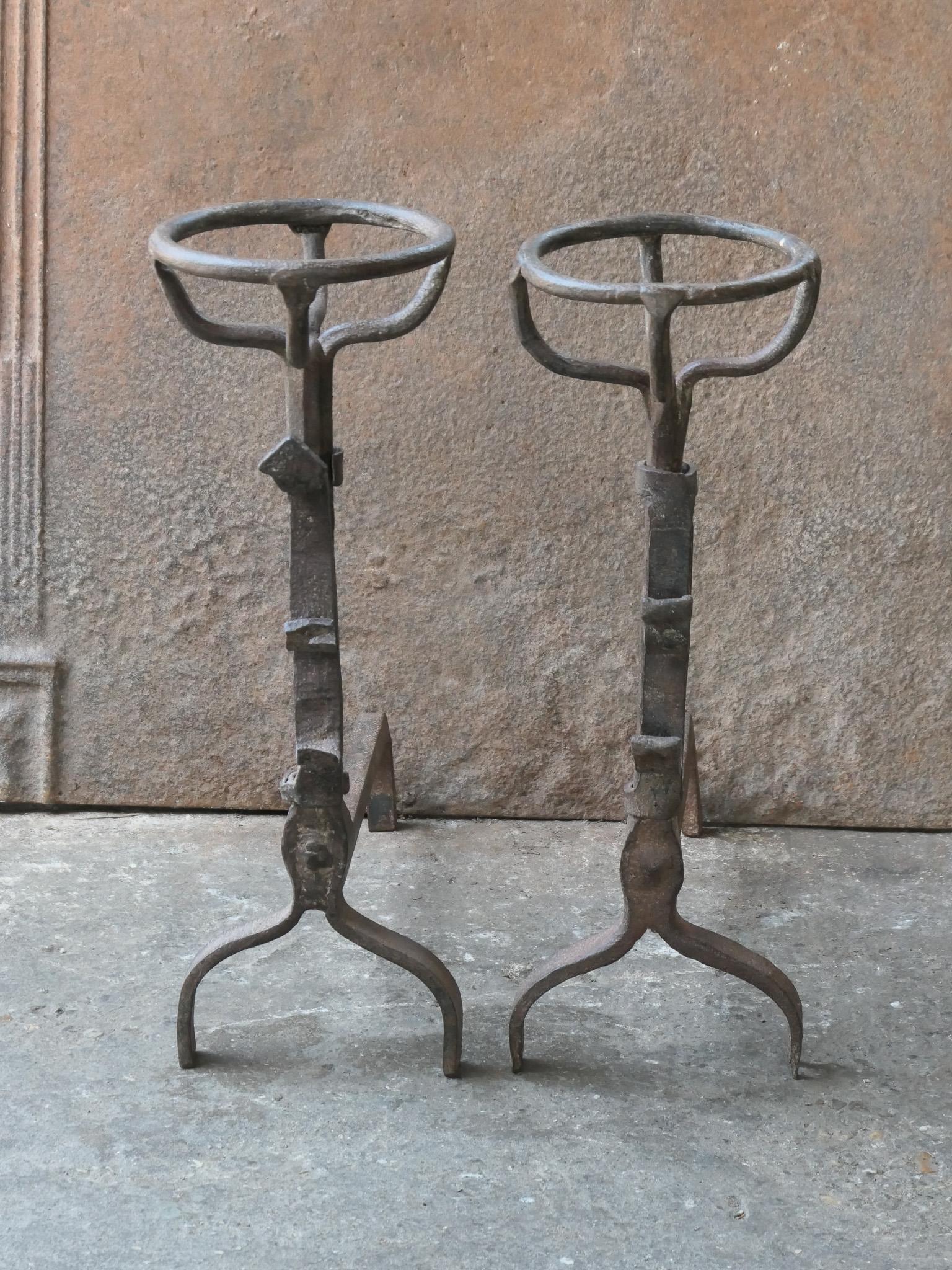 17th century French gothic andirons - fire dogs made of wrought iron. They have spit hooks to grill meat or poultry. 
