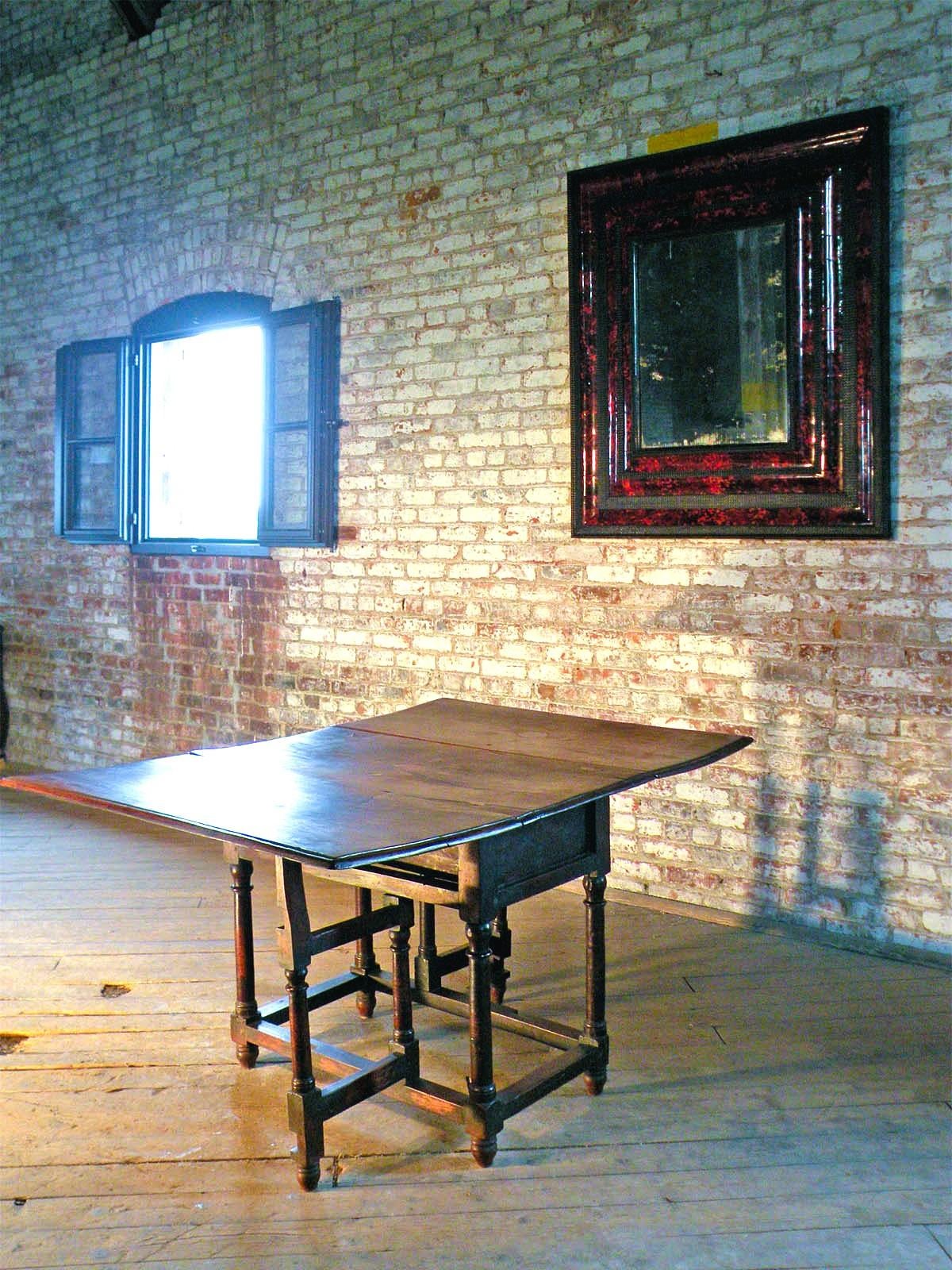 French 17th Century Louis XIII Walnut drop-leaf Table with charming simple Fruitwood inlaid details, columnar legs joined by box-stretchers and columnar swing-legs to support the drop-leaves when opened. The table can be used in various ways, open