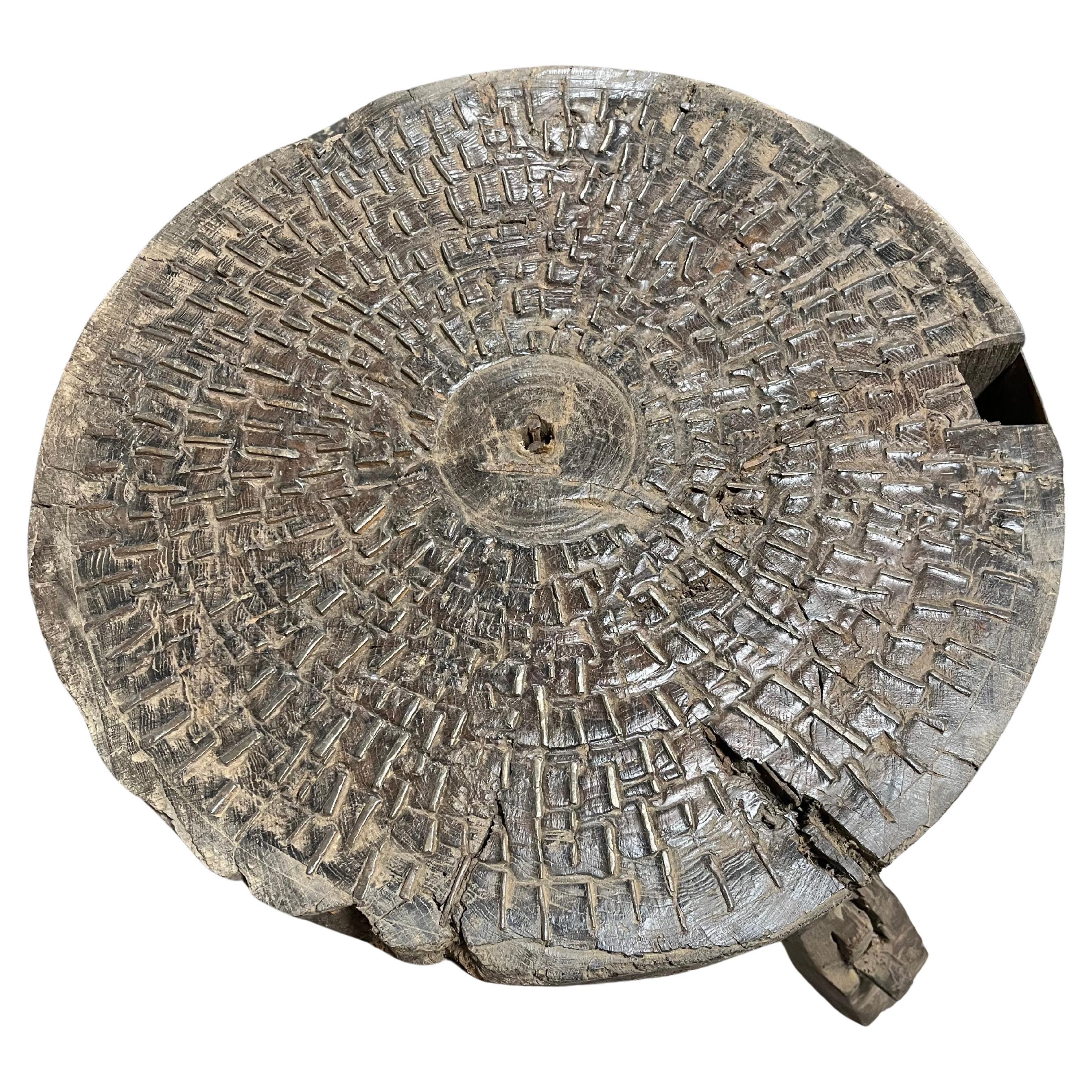 A sensational Arte Populaire Billot used for grinding grains, corn, wheat, etc. It is constructed from a massive billot, chopping block with many iron pieces embedded into the surface of the block. The ground grains would fall out the square opening