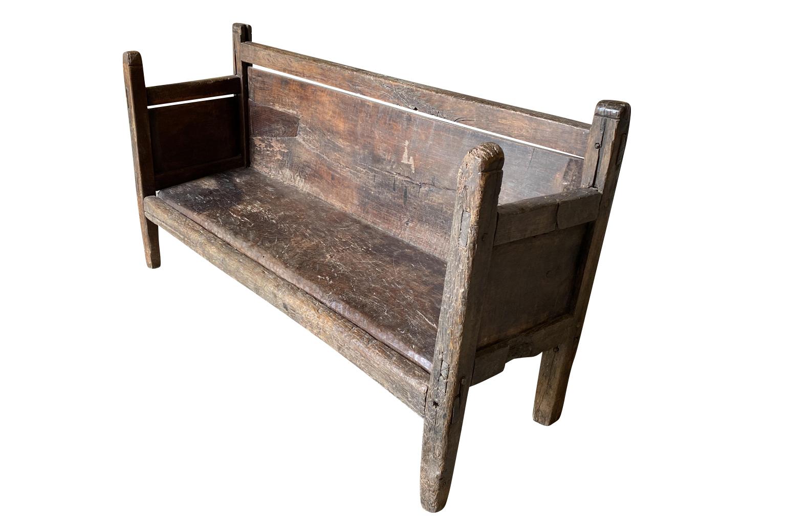 A very charming 17th century bench from the Southwest region of France. Beautifully constructed with solid boards of beautifully stained oak. A stunning bench with gorgeous patina.
