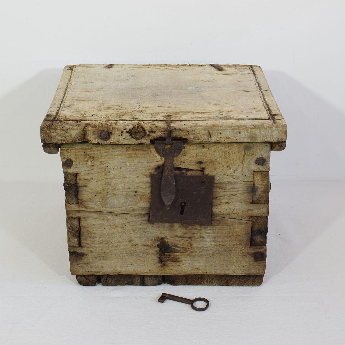 Spectacular weathered wooden box with working lock and original key,
France, 17th century. For its high age in a good condition.
 