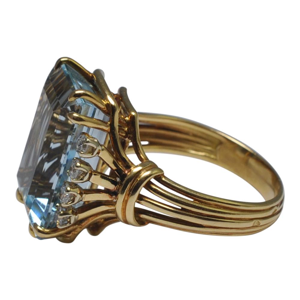 Retro aquamarine and diamond ring in 18ct yellow gold;  this classic cocktail ring dating from around 1950 is set with an emerald cut aquamarine weighing 10.75gms and flanked by 4 8-cut diamonds on either side, totalling 0.24ct.  The ring is on a