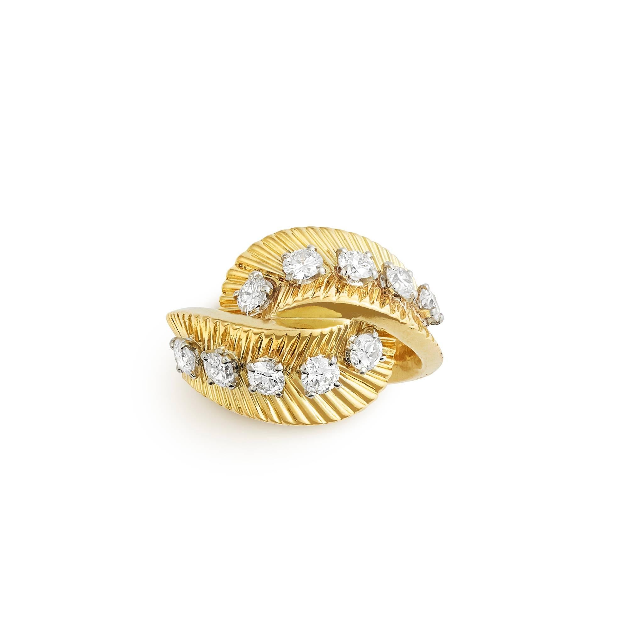 A classic and very attractive ribbed 18ct yellow gold crossover ring set with ten brilliant cut diamonds signed and numbered Van Cleef et Arpels 77145, French circa 1970