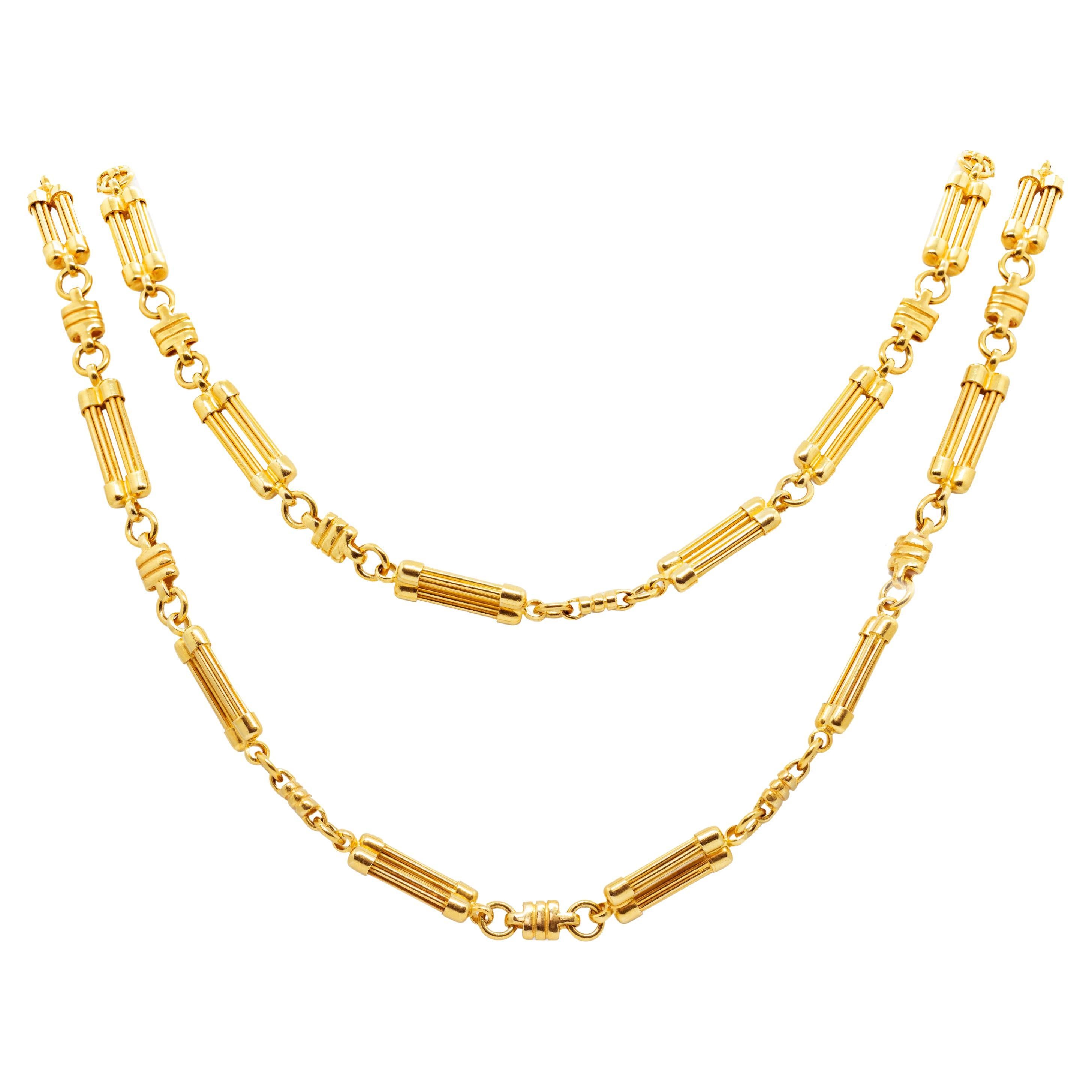 This fancy 18 carat yellow gold chain necklace is beautifully designed with alternating textured double bar links and small textured square links. The sturdy necklace secures with a lobster clasp for guaranteed safe wear, measures 42 inches in
