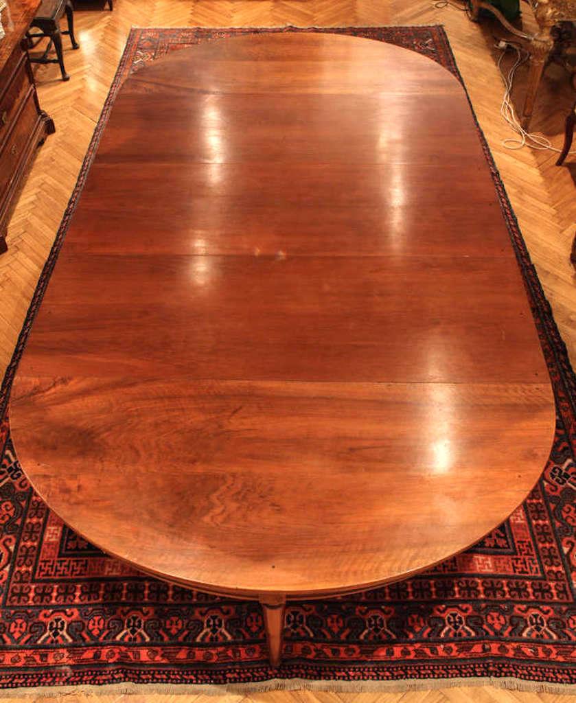 A large late 18th century, French oval extending walnut dining table with paneled frieze and five extensions, legs ending in capes and casters.
Measurements:
Provenance; Hotel particulier, Paris
Measures: Height cm 74.
Width cm 170.
Depth cm