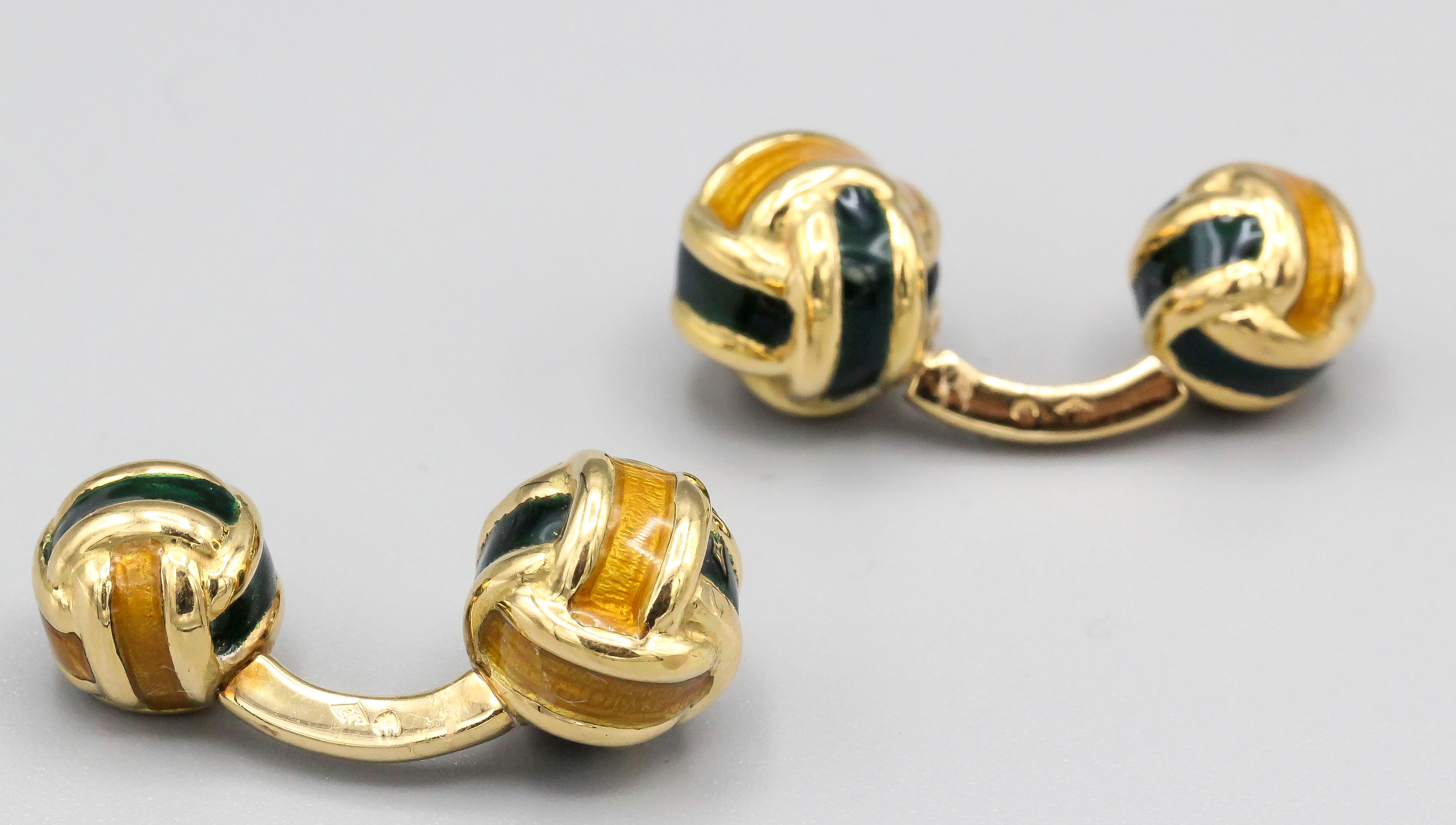 Fine 18K yellow gold and enamel cufflinks of French origin. They resemble knots, with one side slightly larger than the other, and featuring dark green and yellow enamel.

Hallmarks: French 18K gold assay mark, maker's mark.
