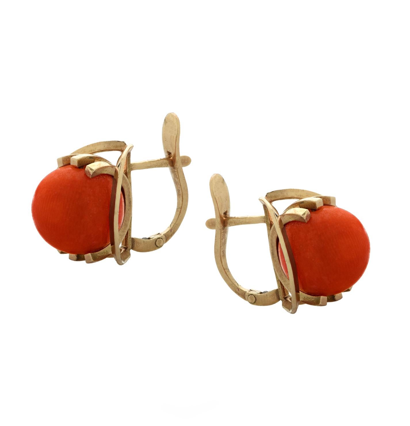 Beautiful French earrings crafted in 18 karat yellow gold featuring two salmon coral beads cradled in gold prongs floating on a gold rim. These celestial earrings measure .48 of an inch in width and 0.5 of an inch in length and weigh 6.6 grams.  