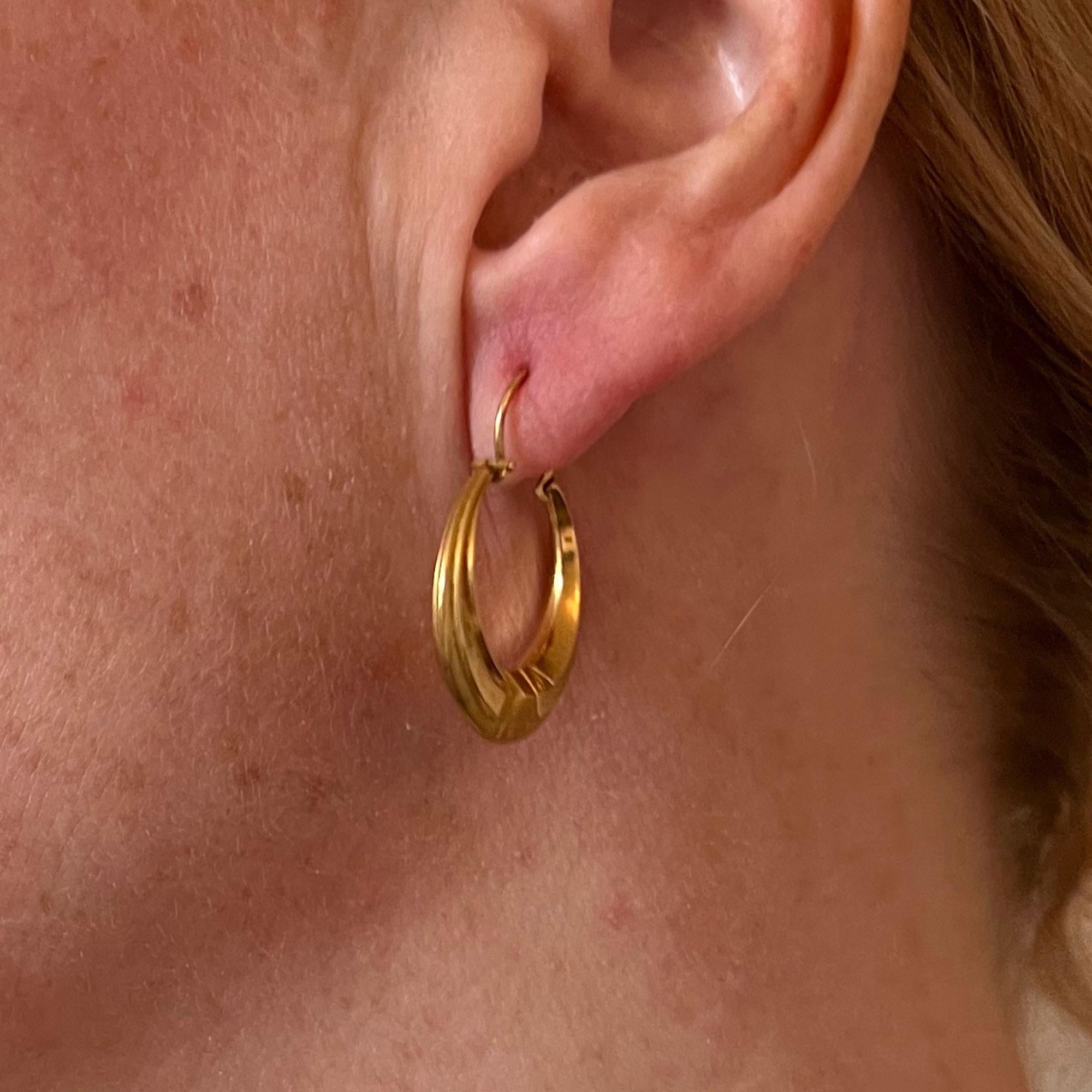 A pair of French 18 karat (18K) yellow gold hoop earrings, each designed as a Creole hoop. For pierced ears. Stamped with the eagle’s head for 18 karat gold and French manufacture with an unknown makers mark.

For pierced ears.
Dimensions: 2.8 x 2.1