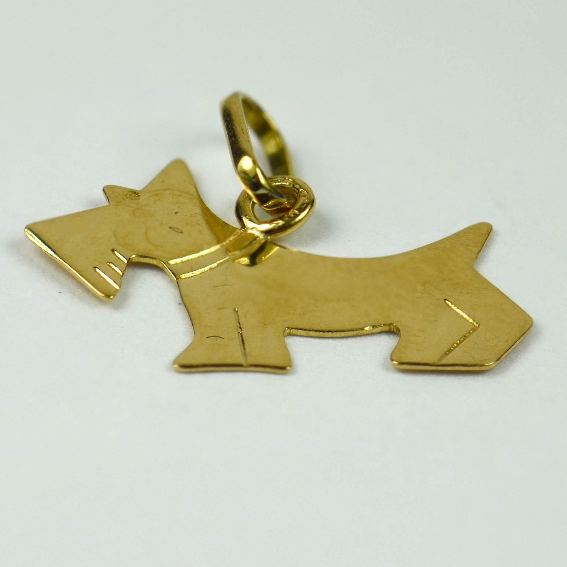 An 18 karat (18K) yellow gold charm pendant designed as the profile of a Terrier or Scottie breed of dog. Stamped with the eagle's head for French manufacture and 18 karat gold.

Dimensions: 1.5 x 1.8 x 0.1 cm
Weight: 0.56 grams
