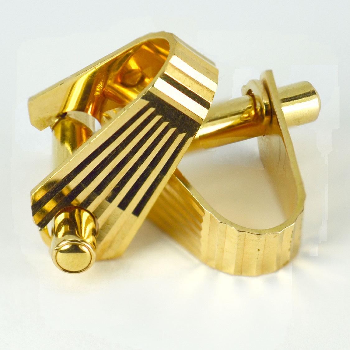 A smart pair of French 18 Karat yellow gold stirrup cufflinks with ridged detail. Marked ‘MECAN’ for Mecan Elde, and stamped with the eagles head for 18 karat gold and French manufacture with an unknown makers mark.

Dimensions: 2 x 2.2 x 1