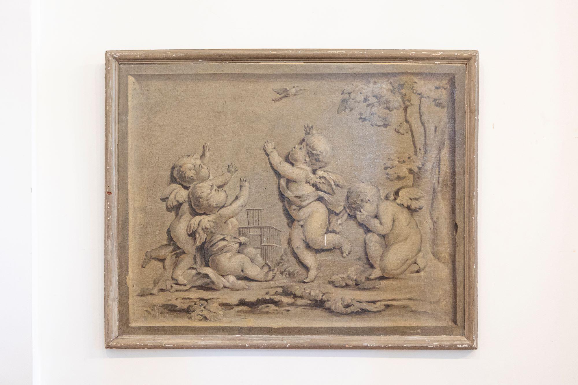 A French grisaille painting of horizontal format from the early 19th century. This French grisaille painting features a scene reminiscent of French sculptor Jean-Baptiste Pigalle's 1750s 'Infant with a Cage'. Three chubby cherubs surrounding an