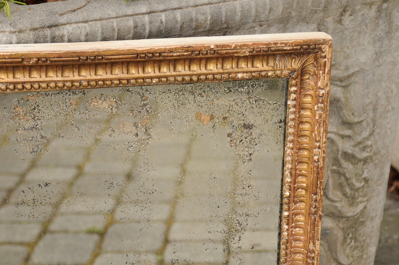19th Century French 1820s Restauration Period Giltwood Mirror with Scoop Patterns and Beads