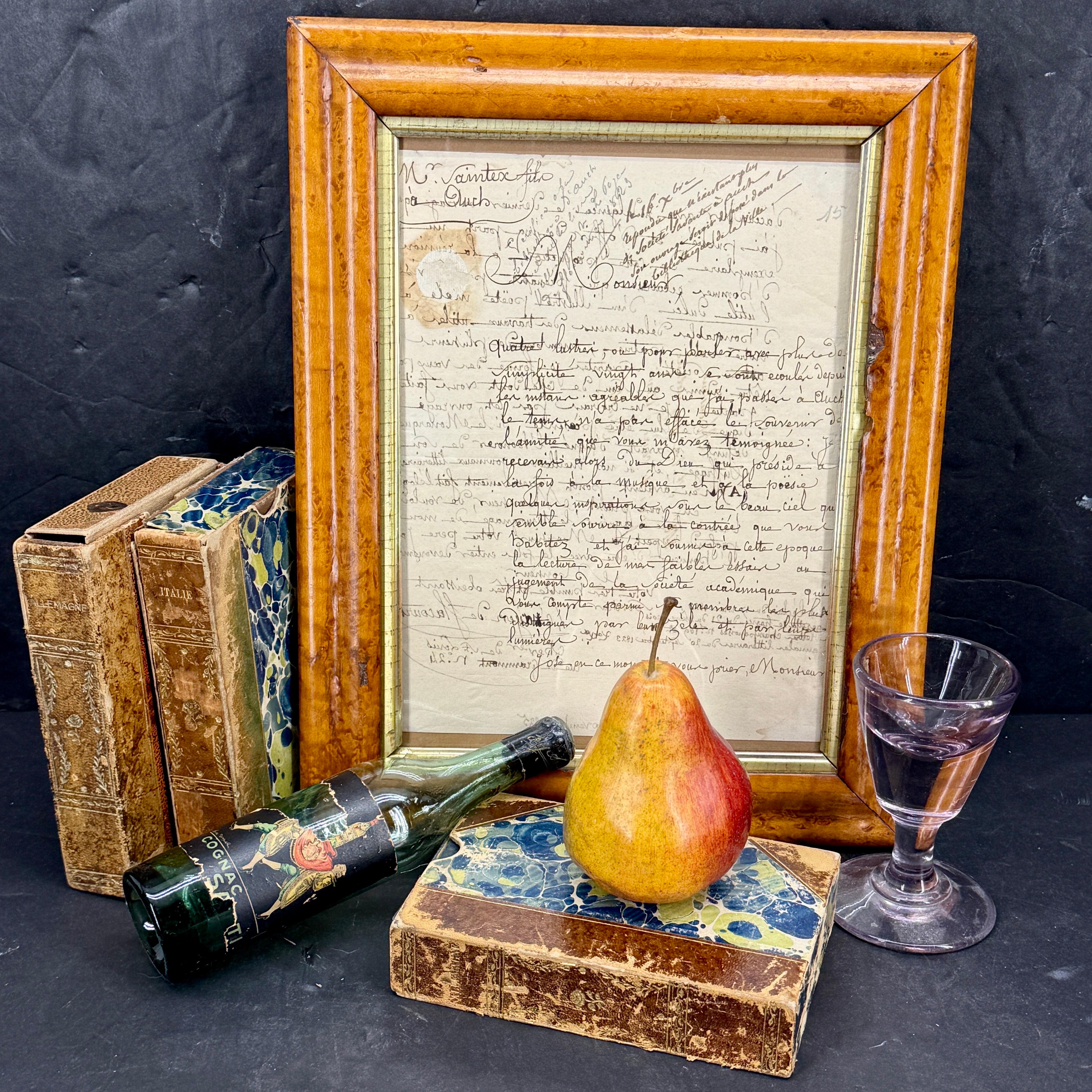 Custom burl wood framed art that features an antiquarian handwritten letter in French, dated 