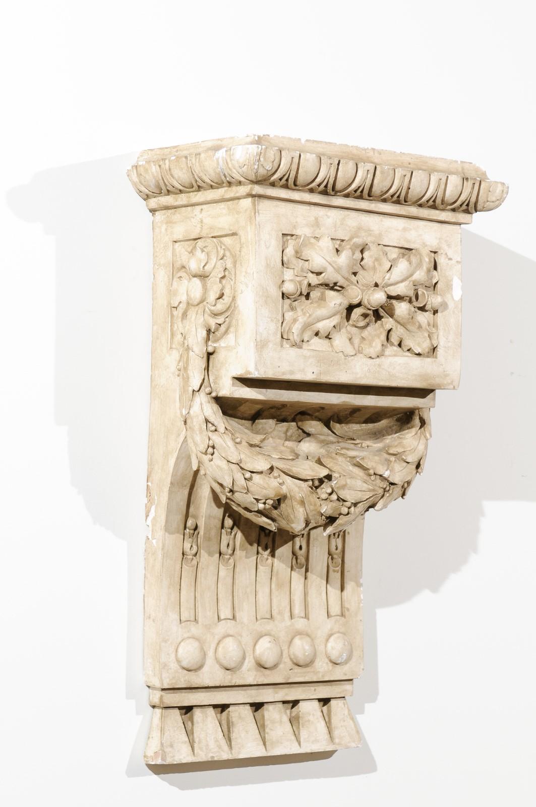 A French Louis-Philippe period stucco wall bracket decoration from the mid-19th century, with egg-and-dart and garland motifs. Born in France during the early years of king Louis-Philippe's reign, this exquisite stucco wall bracket features an egg