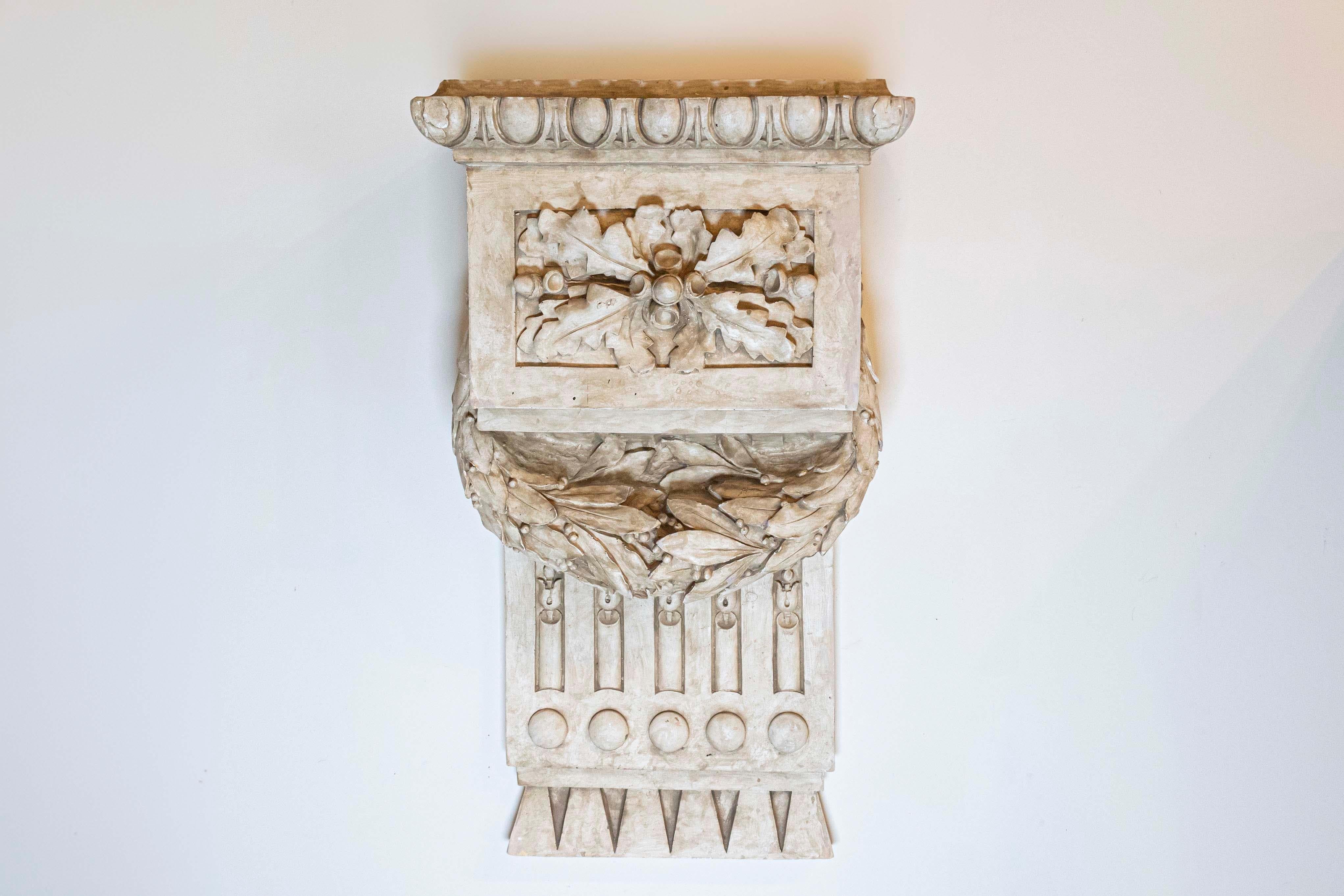 A French Louis-Philippe period stucco wall bracket decoration from the mid-19th century, with egg-and-dart and garland motifs. Born in France during the early years of king Louis-Philippe's reign, this exquisite stucco wall bracket features an egg