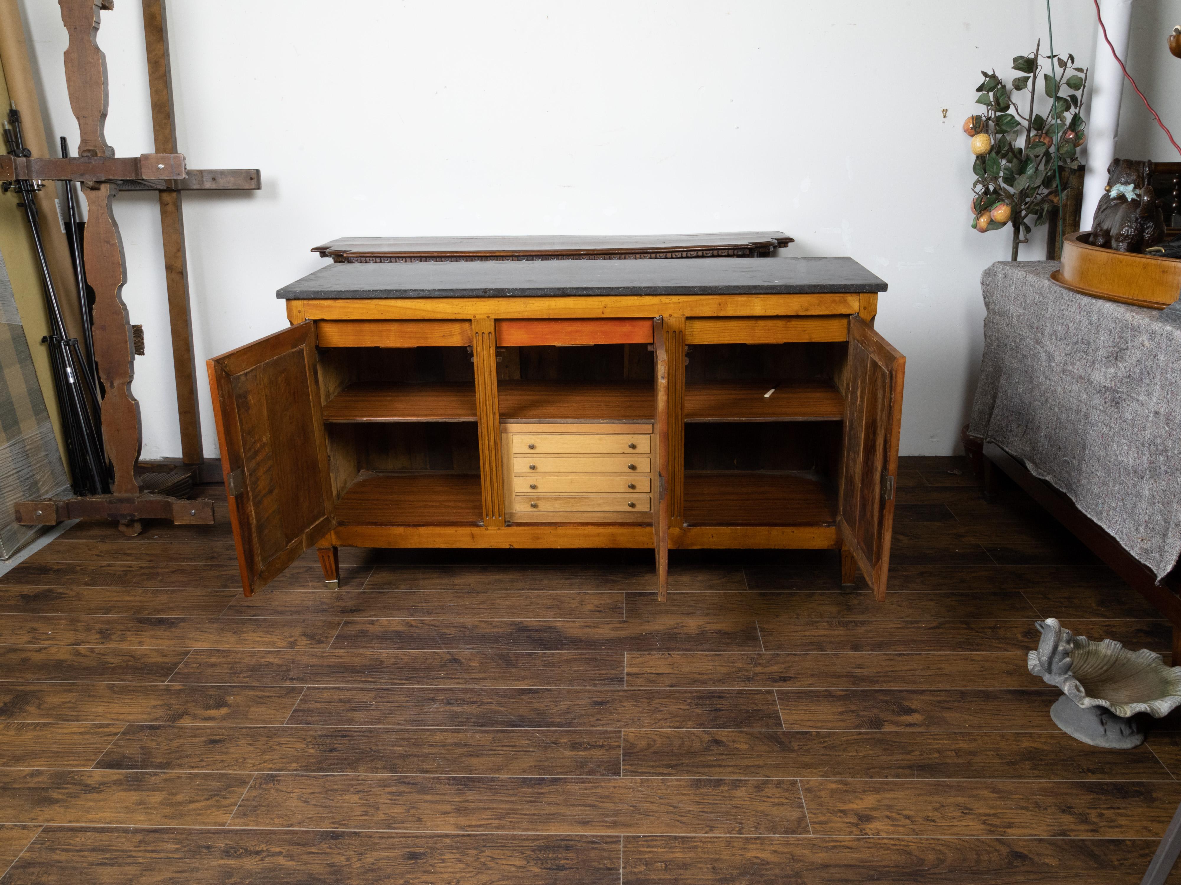 A French walnut enfilade from the mid 19th century, with black marble top, silverware drawers, recessed panels and fluted motifs. Created in France during the second quarter of the 19th century, this walnut enfilade features a rectangular black /