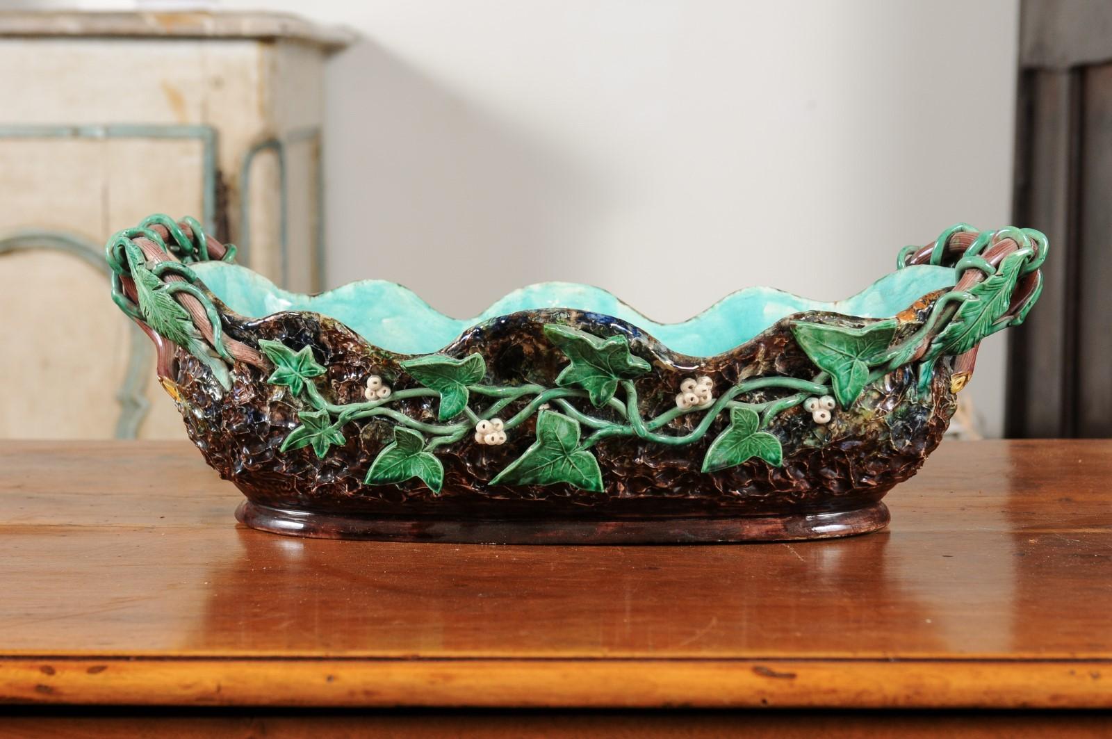 A French mid-19th century barbotine Majolica jardinière by French potter Thomas Sargent, with floral motifs. Born in France during the 19th century, this Palissy inspired Majolica jardinière features a lovely barbotine décor of delicate pastel