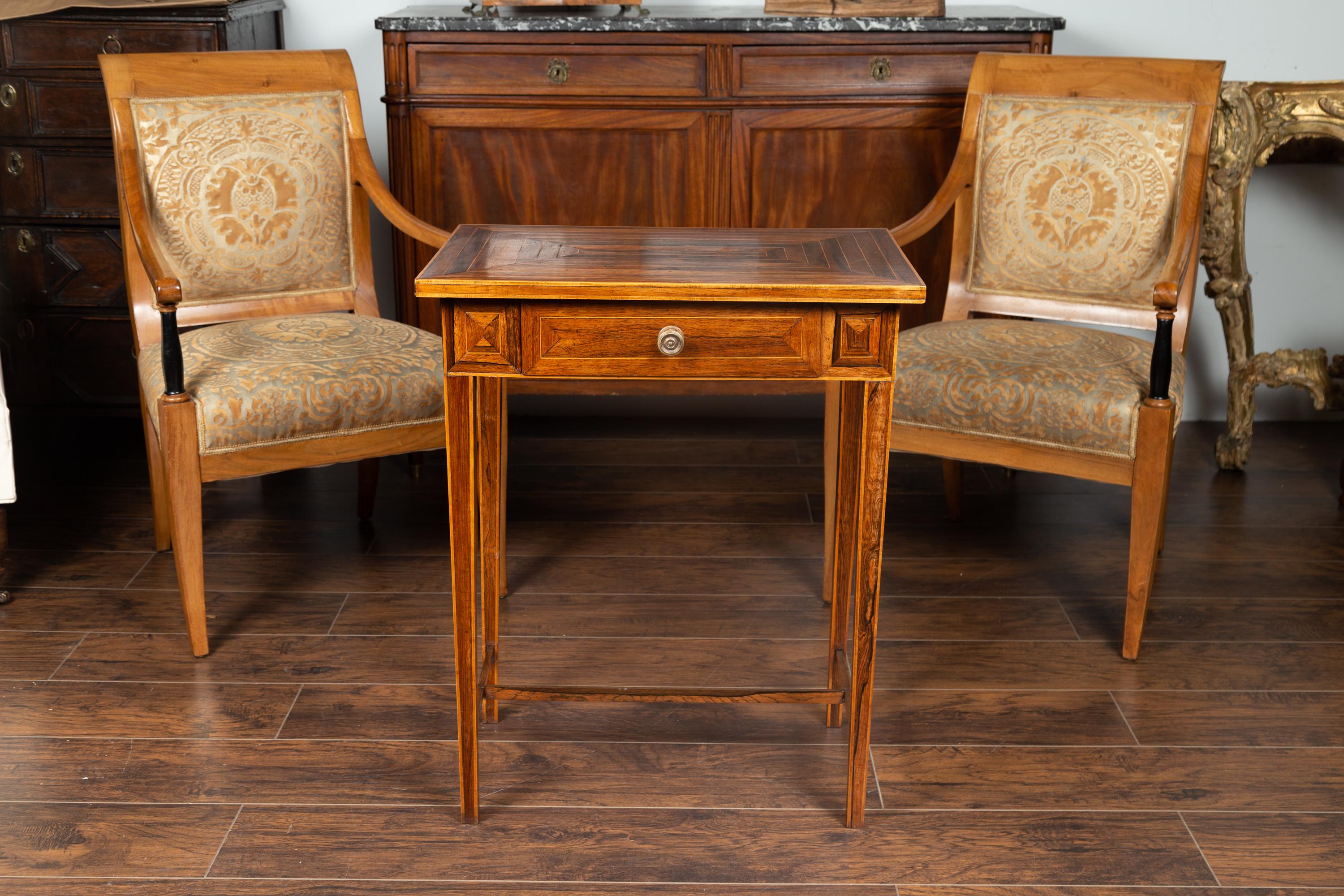 A French Napoleon III period walnut side table from the mid 19th century, with geometric inlay, single drawer and tapered legs. Born in France during the early years of emperor Napoleon III's reign, this side table features a rectangular top adorned