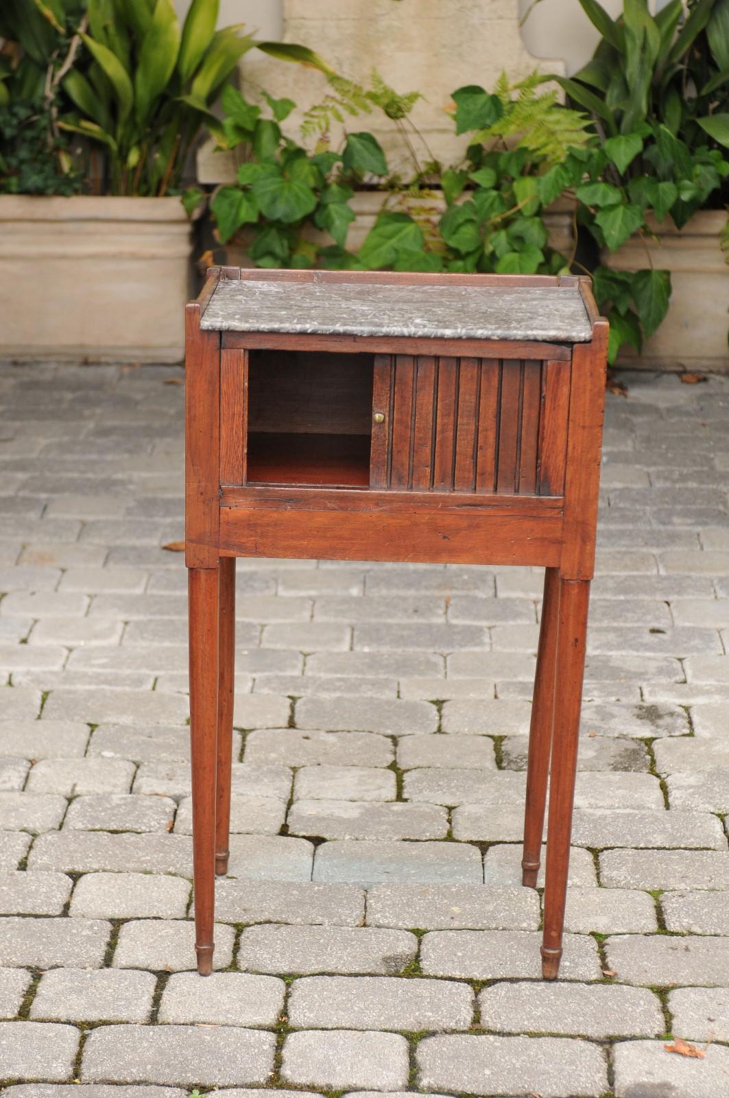 Français Table d'appoint française des années 1860 en noyer avec porte à tambour, plateau en marbre et pieds fuselés en vente