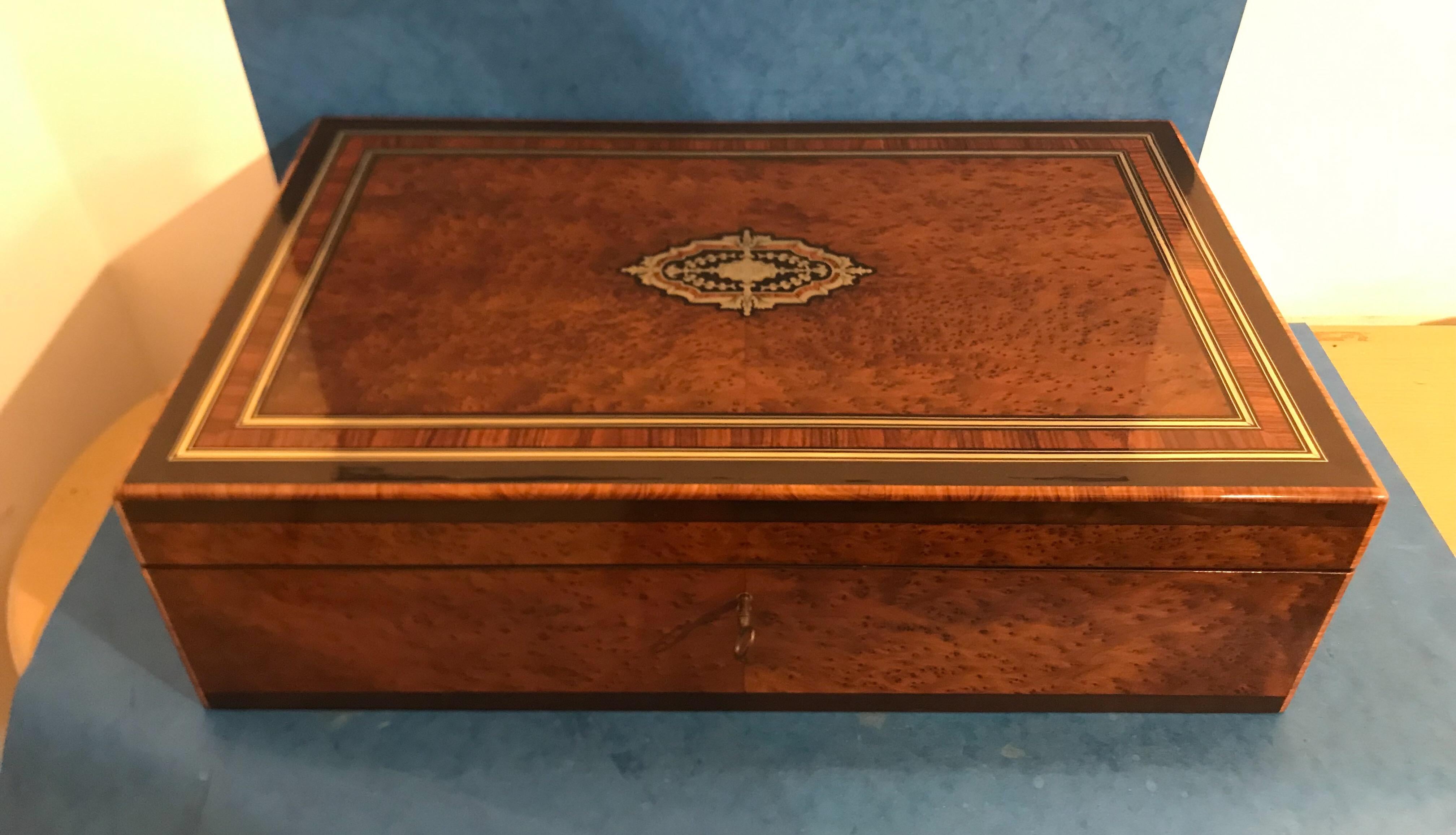 A superb French 1870 Burr Cedar, edged in ebonised fruit wood and cross banded in Tulipwood and Kingwood, large jewellery trunk, it’s brass inlaid with a original working lock and key and its original red silk interior and fitted tray, it measures