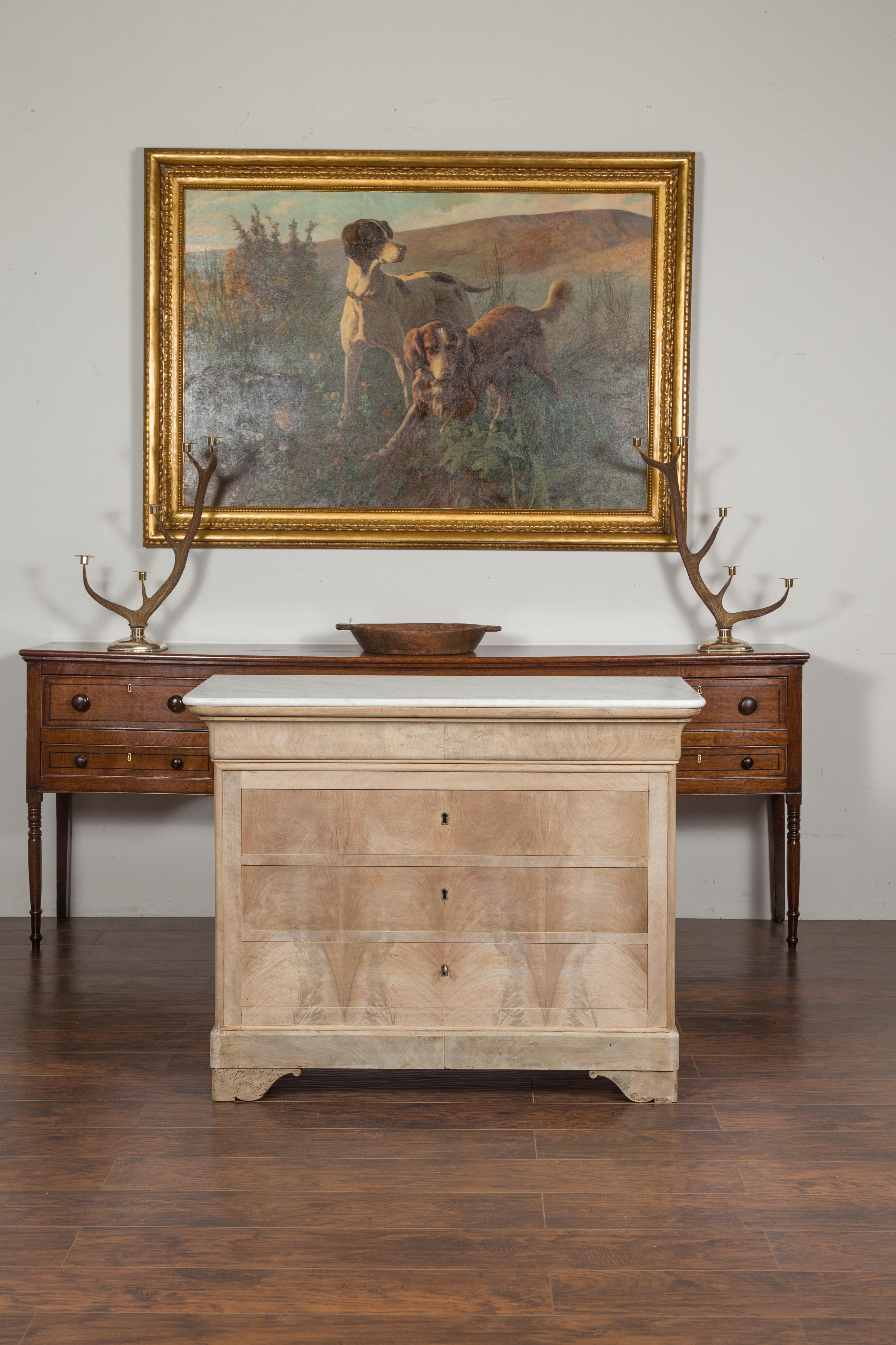 A French Louis-Philippe style bleached wood commode from the late 19th century, with new white marble top and four drawers. Born in France during the third quarter of the 19th century, this Louis-Philippe style commode features a rectangular white