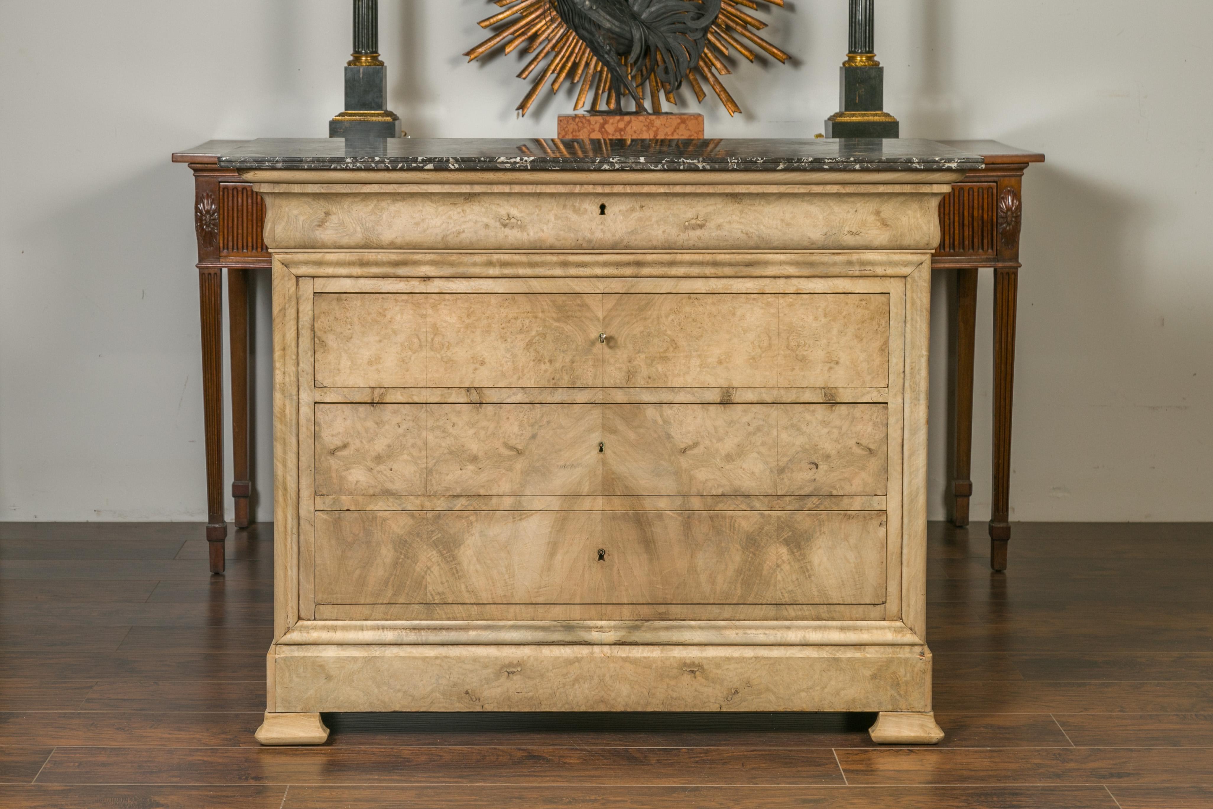 A French Louis-Philippe style bleached burl wood commode from the late 19th century, with grey marble top and four drawers. Born in France during the third quarter of the 19th century, this Louis-Philippe commode features a rectangular variegated