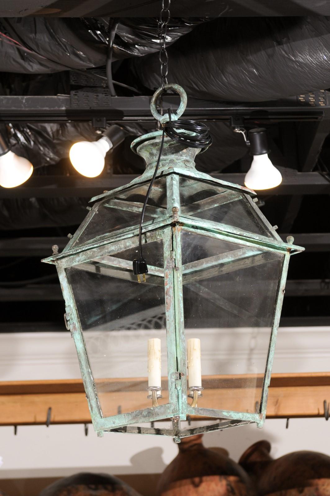 A French Napoléon III copper lantern from the late 19th century, with four lights and verdigris patina. Created in France during the last quarter of the 19th century, this copper lantern features a tapering silhouette boasting a nicely oxidized