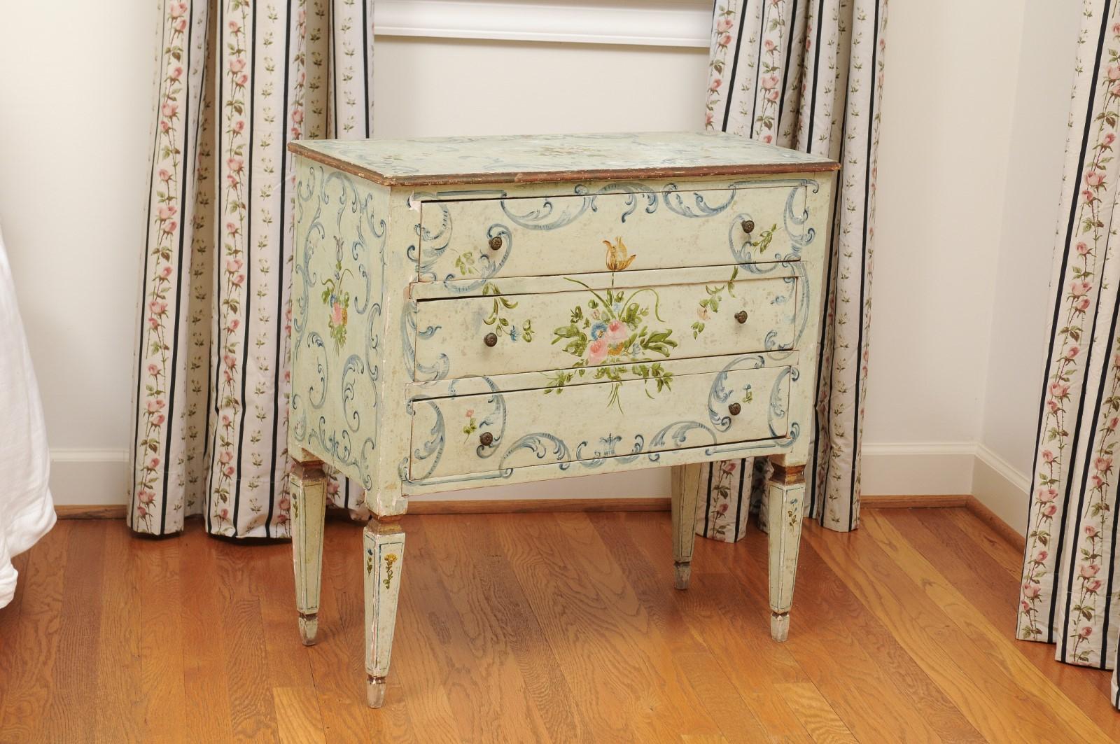 A French Napoléon III three-drawer chest from the late 19th century, with painted floral decor. Created in France at the end of Emperor Napoléon III's reign, this chest features a linear Silhouette, adorned with a delicate decor of flowers and