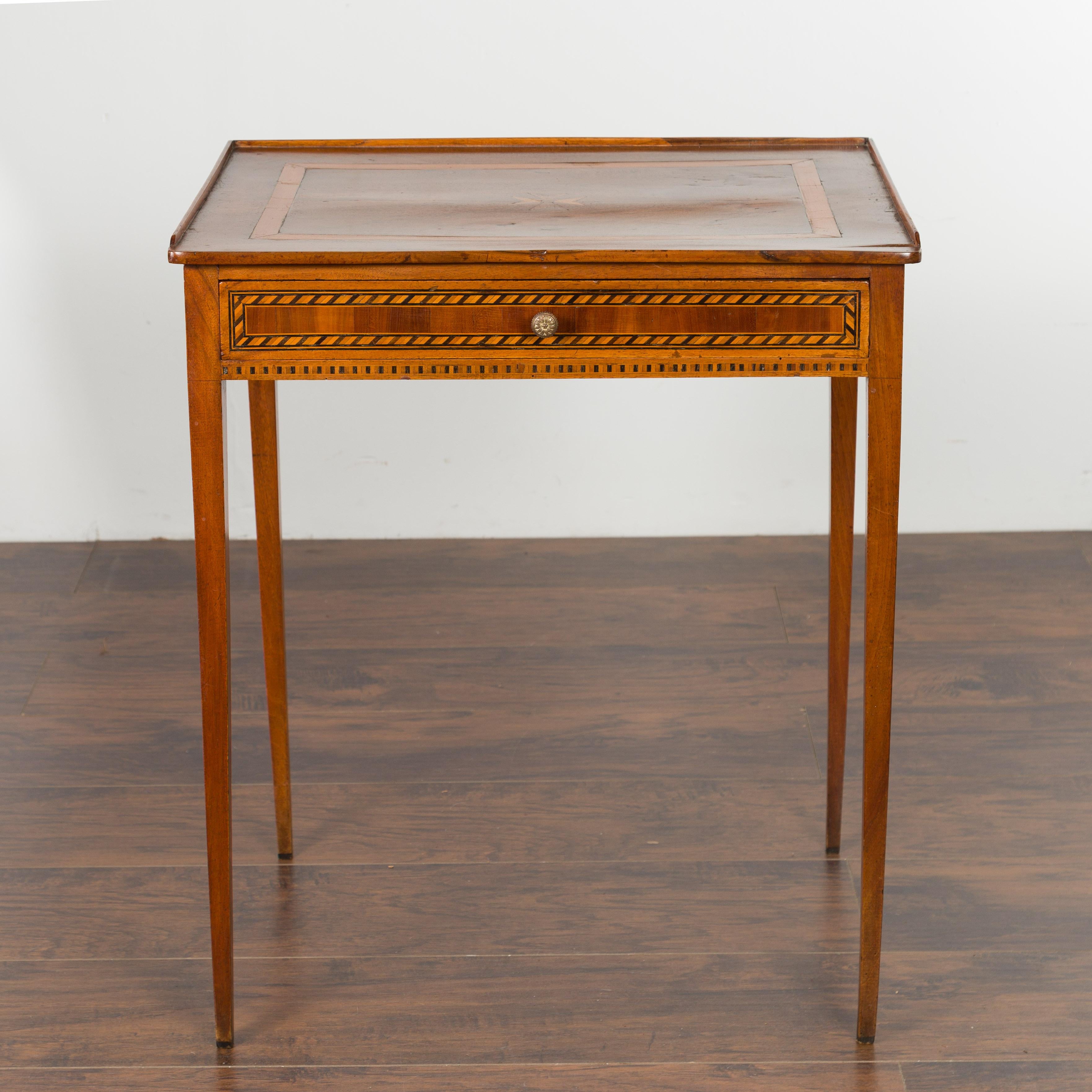 A French Napoléon III walnut side table from the late 19th century, with start inlay and single drawer. Created in France at the end of Emperor Napoléon III's reign, this walnut side table features a rectangular top with three quarter gallery,