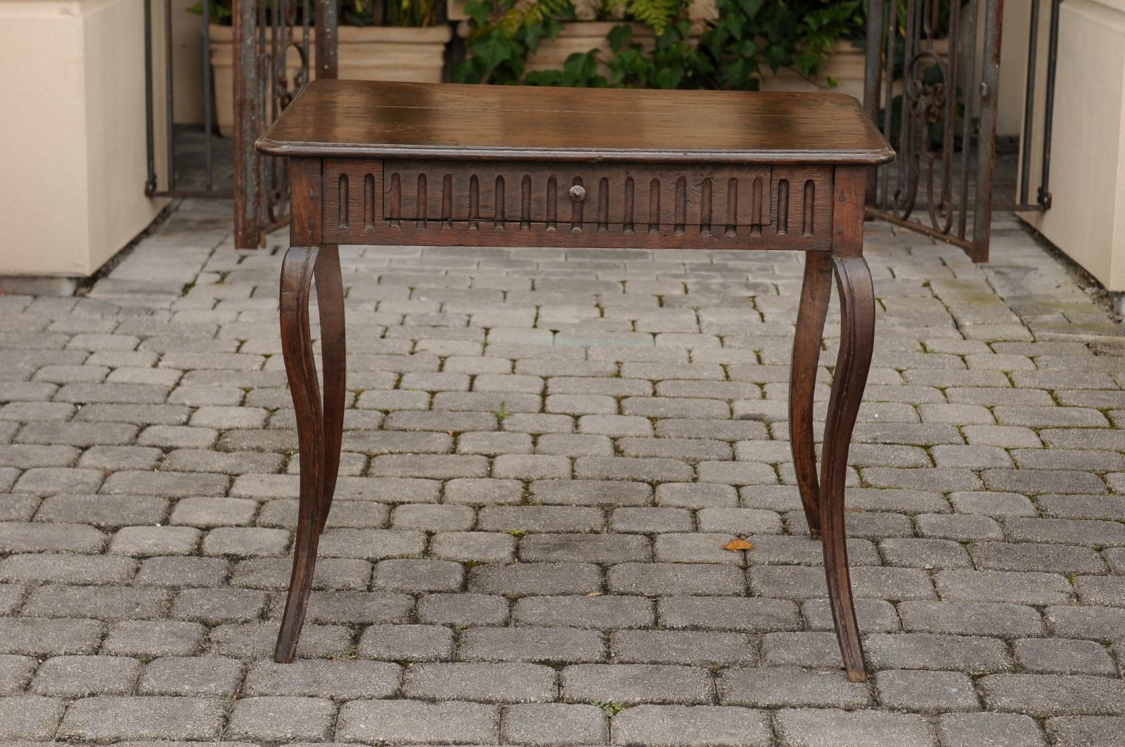 A French chestnut and oak table from the third quarter of the 19th century, with single drawer and cabriole legs. Born at the end of the reign of France's last Emperor Napoleon III, this oak and chestnut table features a rectangular planked top with