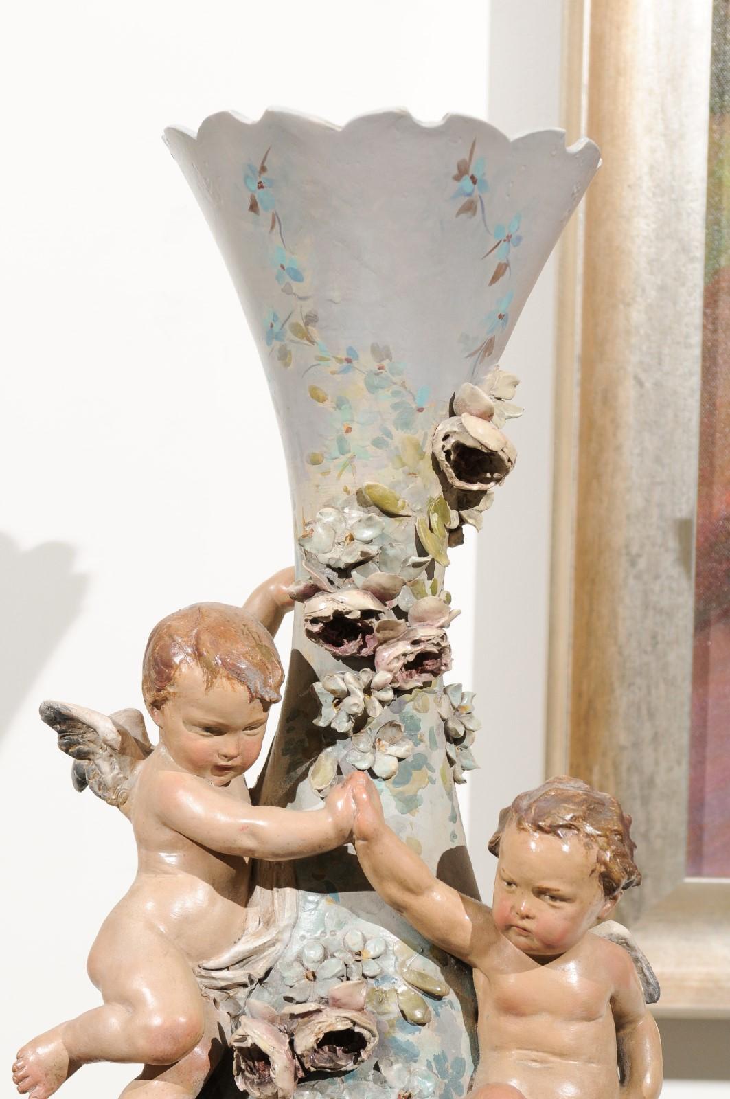 French 1870s Slender Majolica Vase with Floral Décor and High-Relief Cherubs For Sale 4