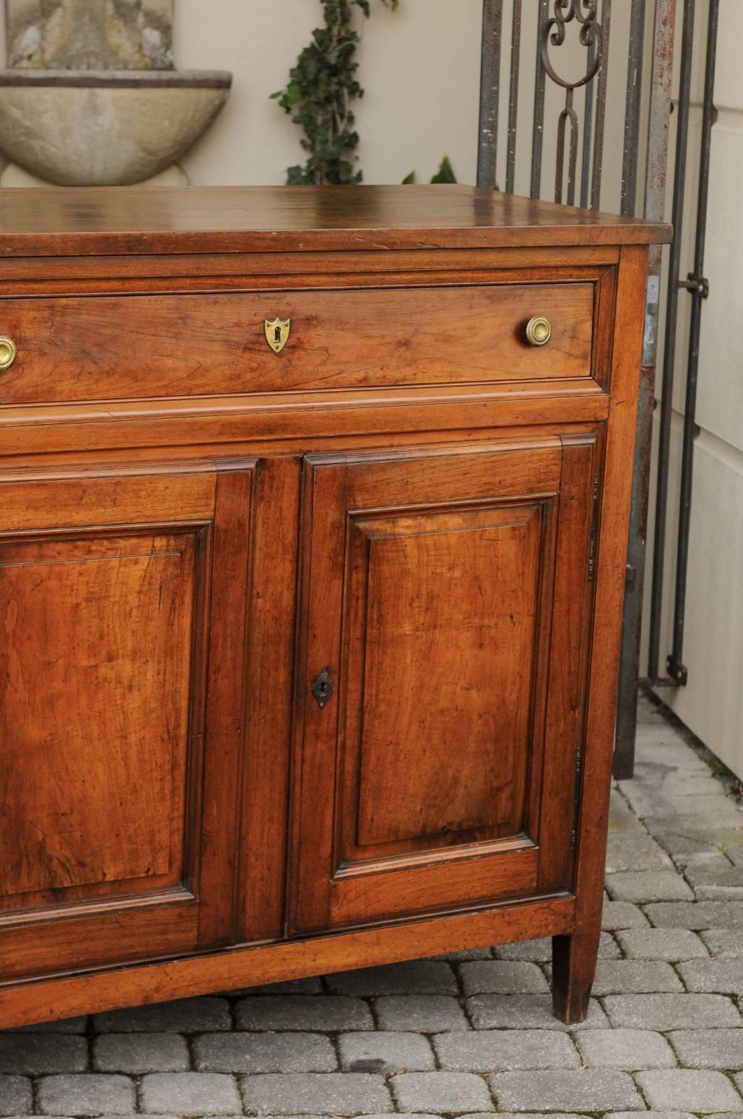 A French walnut tall buffet from the second half of the 19th century, with long partitioned drawer and two doors. Born during the later years of Emperor Napoleon III's reign, this walnut buffet features a rectangular planked top, sitting above a