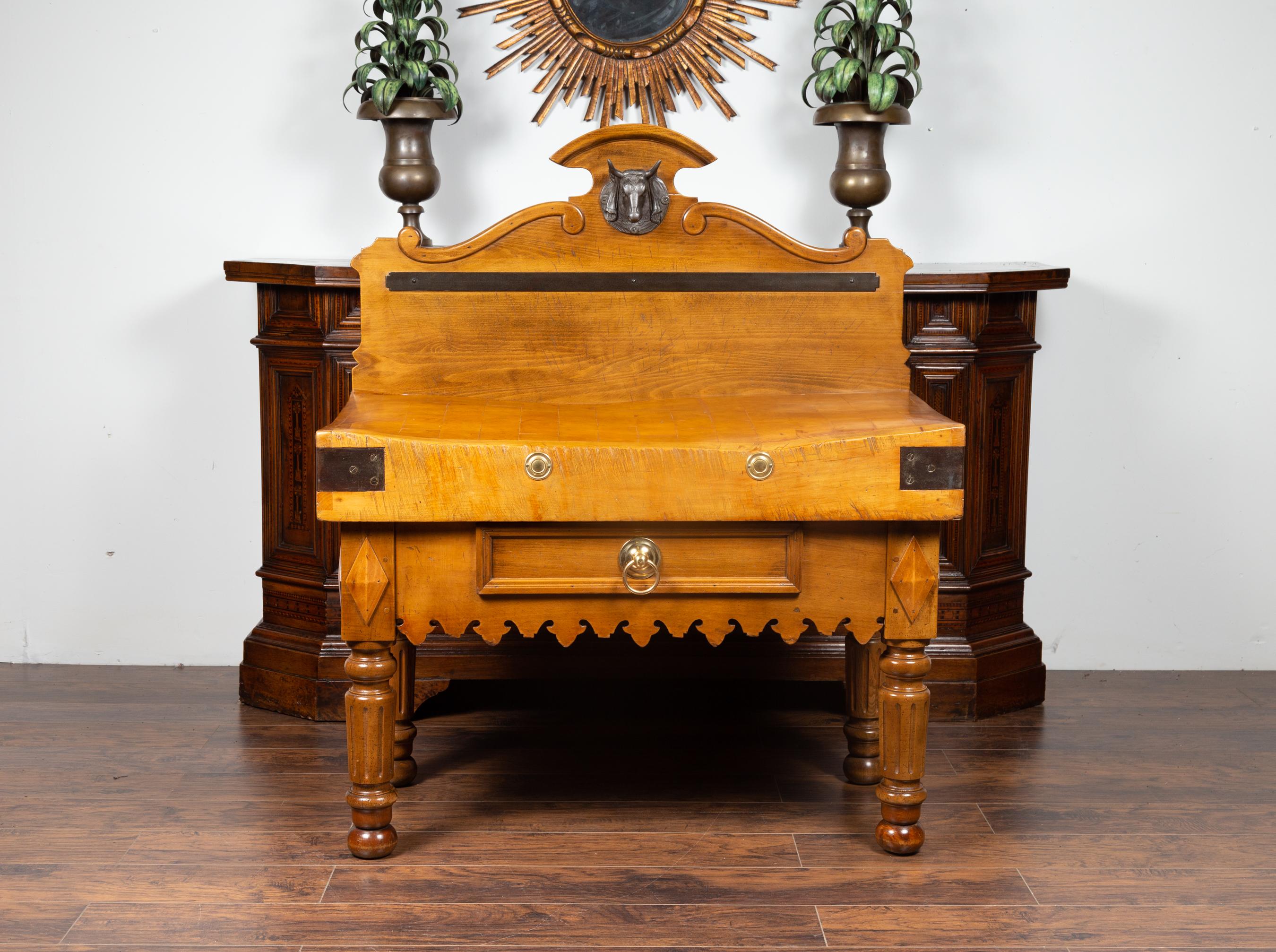 A French butcher block from the late 19th century, with carved wooden bull head, single drawer and volutes. Born in France during the last quarter of the 19th century, this stunning butcher block captures our attention with its great proportions,