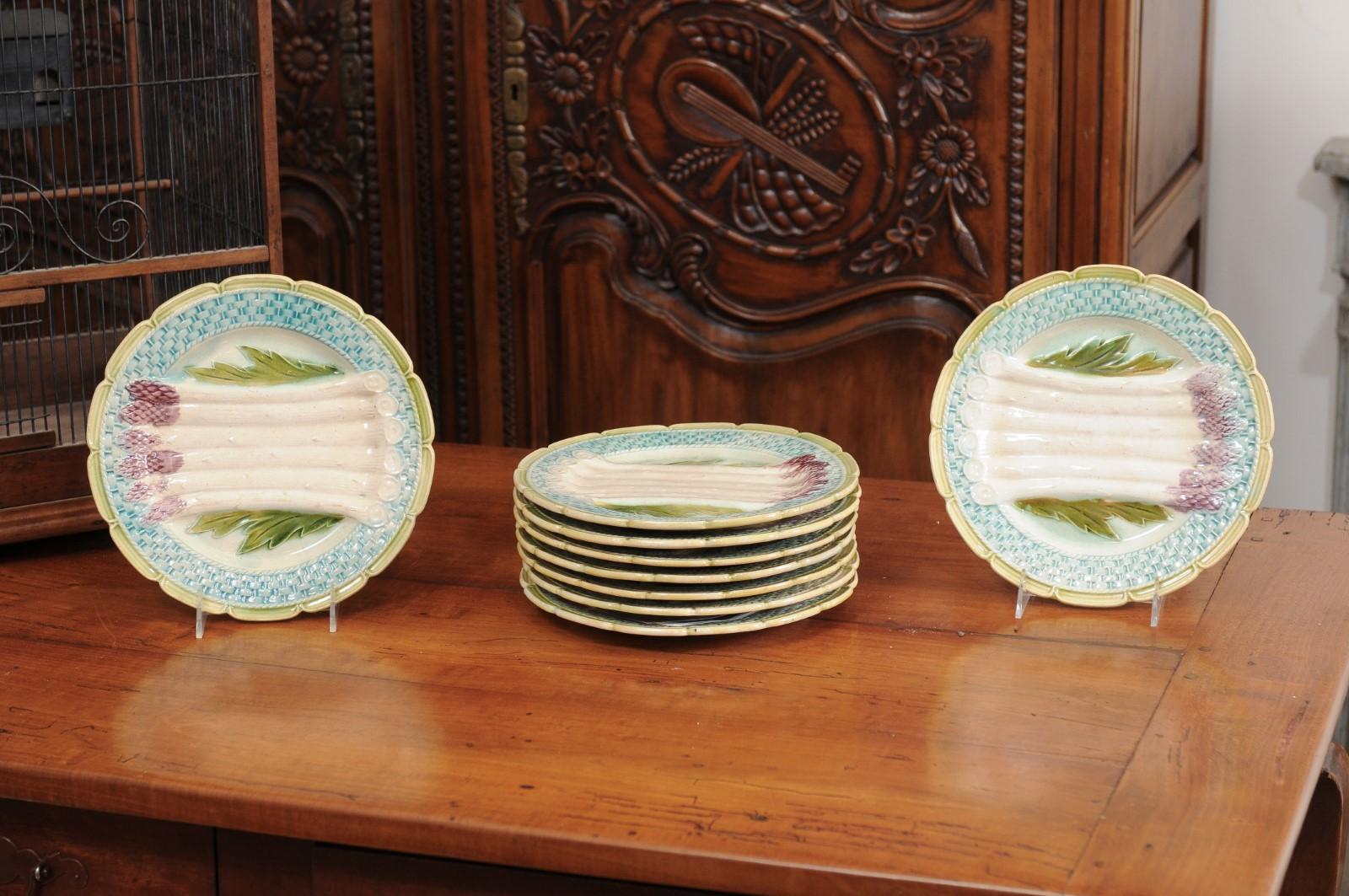 A French Majolica asparagus plate from the late 19th century, with scalloped edge and turquoise and green accents. We currently have nine plates available, priced and sold individually $195 each. Created in France during the last quarter of the 19th