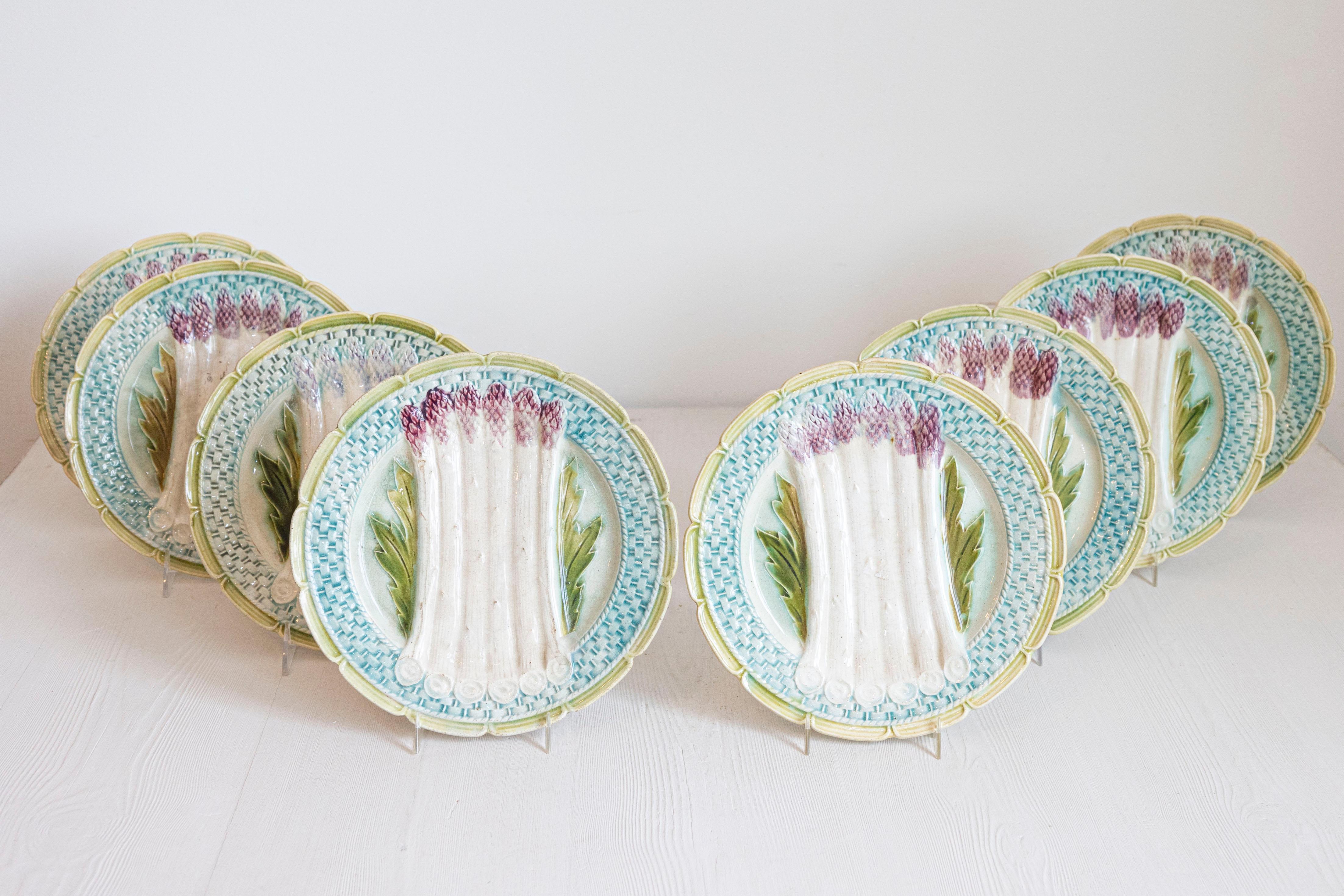 A French Majolica asparagus plate from the late 19th century, with scalloped edge and turquoise and green accents. We currently have nine plates available, priced and sold individually $195 each. Created in France during the last quarter of the 19th