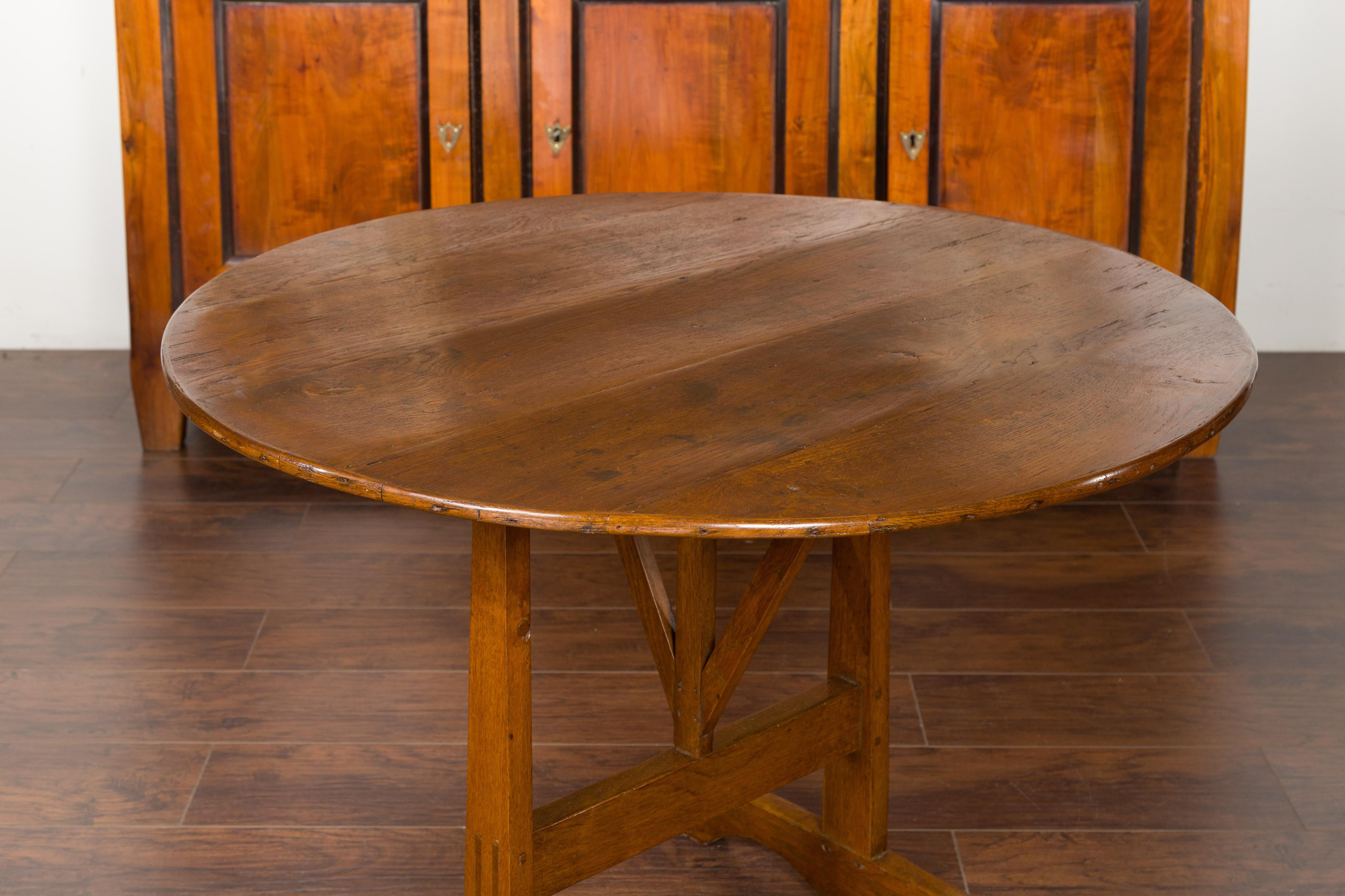 Rustic French 1880s Oak Wine Tasting Table with Round Tilt-Top and Trestle Base For Sale