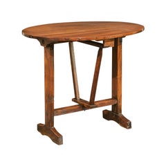 French 1880s Walnut Wine Tasting Table with Oval Tilt-Top and Trestle Base