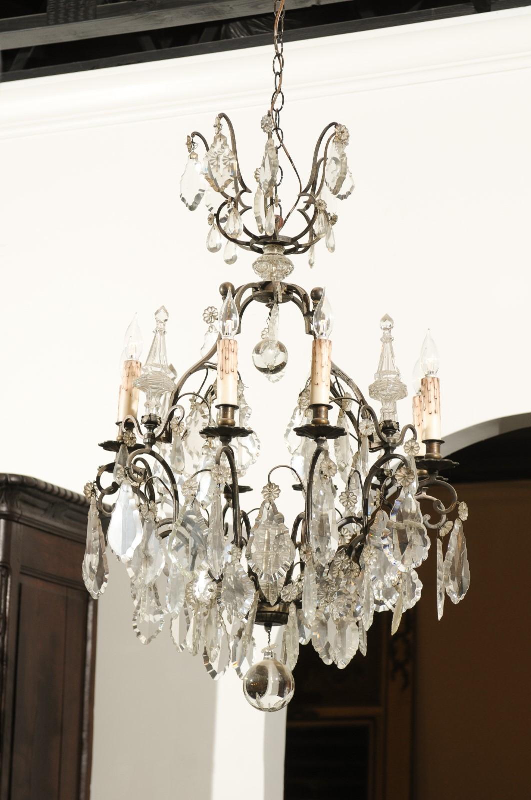 A French eight-light crystal chandelier from the late 19th century, with bronze armature and crystal obelisks. Born in France during the last decade of the 19th century, this exquisite eight-light chandelier features a bronze armature accented with