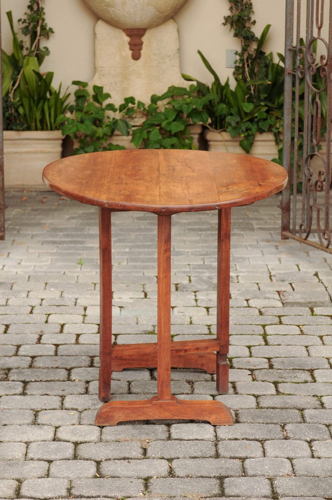 French 1890s Fruitwood Wine Tasting Table with Oval Tilt Top and Trestle Base 4