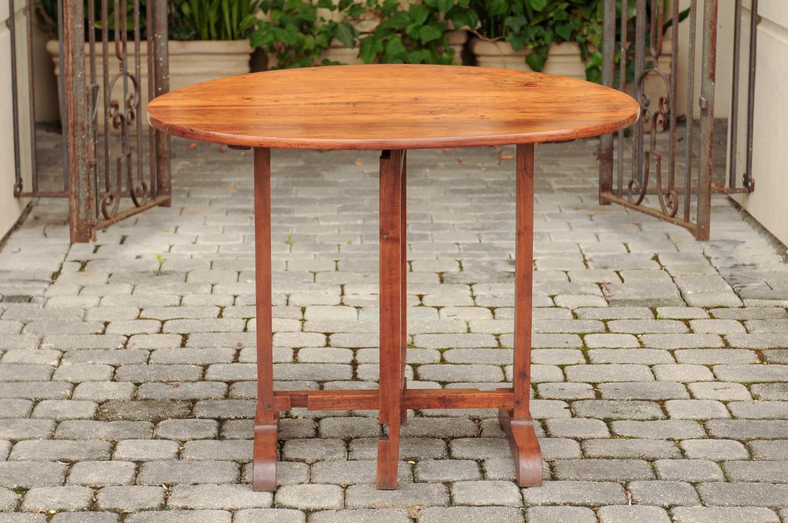 French 1890s Fruitwood Wine Tasting Table with Oval Tilt Top and Trestle Base 5