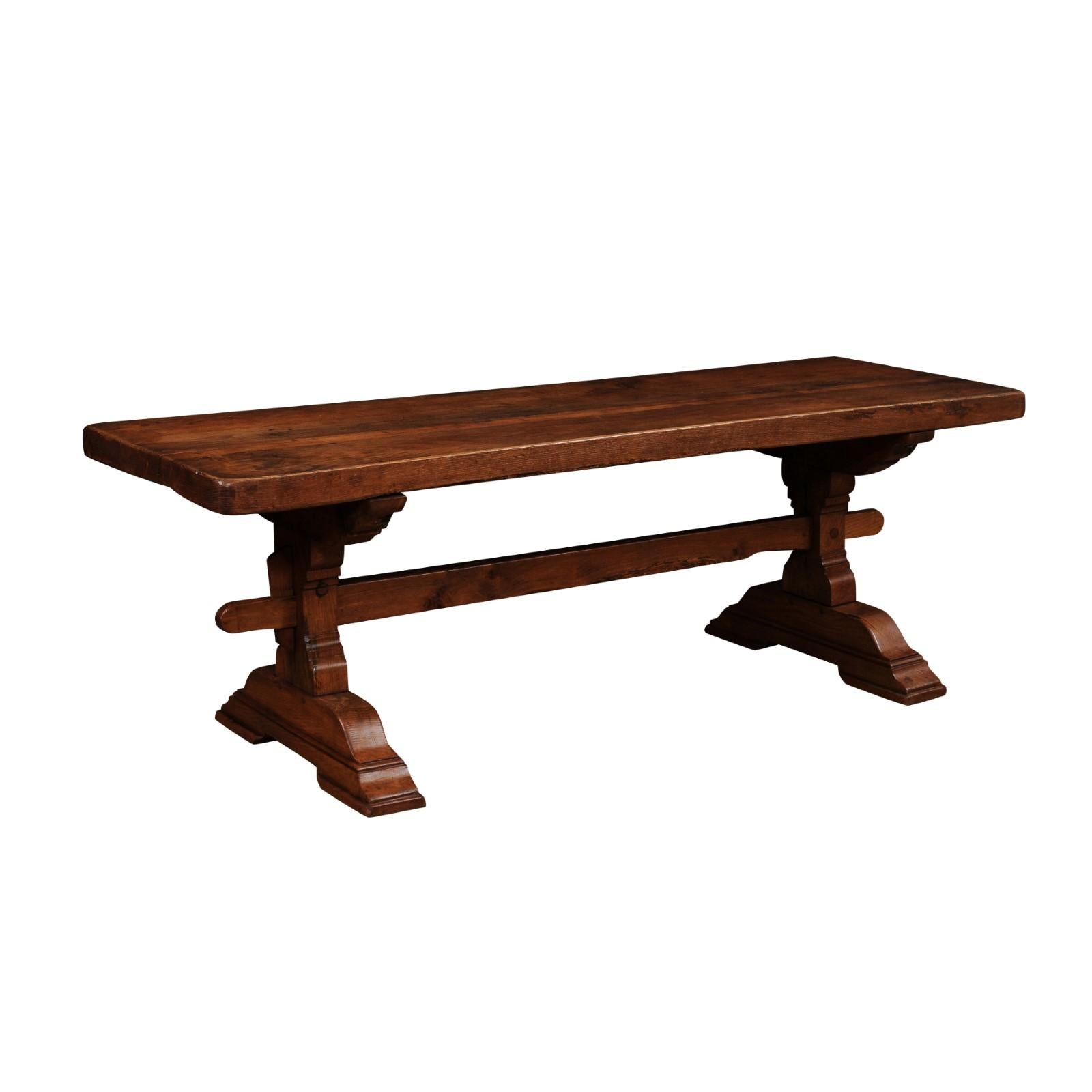 A French solid oak monastery table from circa 1890 with trestle base. This French solid oak monastery table, dating back to around 1890, is a testament to timeless craftsmanship and enduring authenticity. Crafted from substantial European oak, its